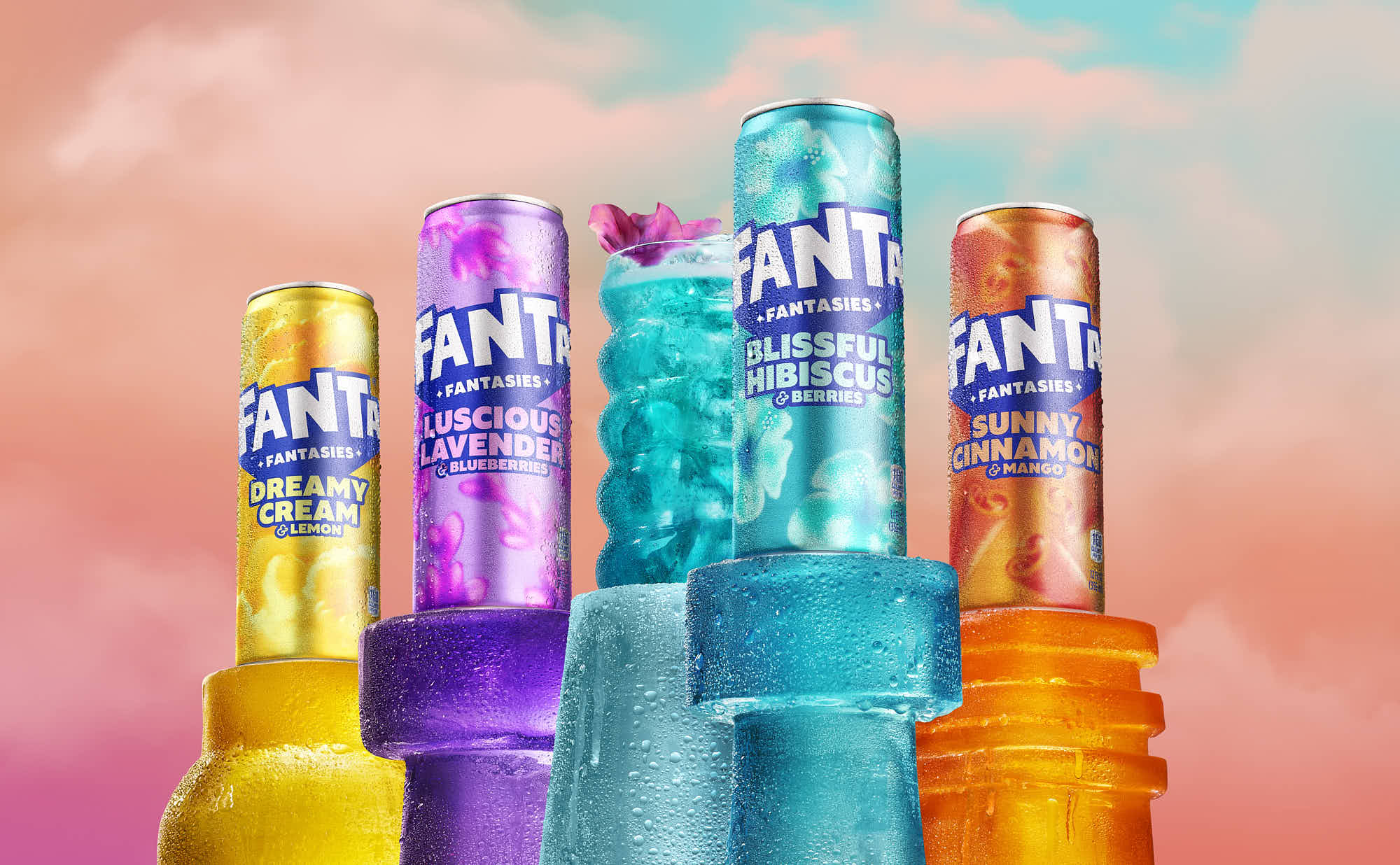 Brightly colored Fanta cans in various shades of blue, pink, and yellow stand against a colorful, pastel background.