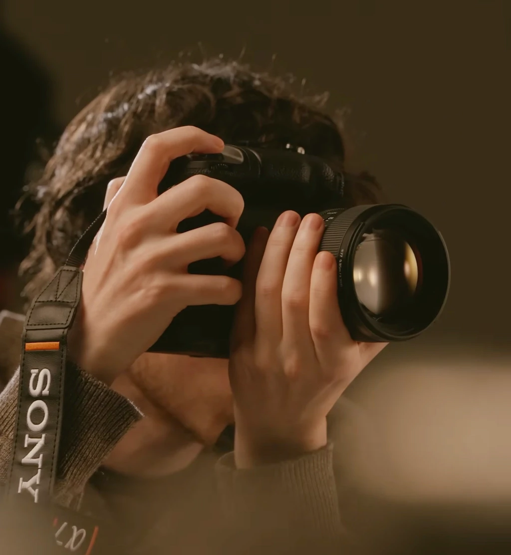 Man holding camera up to take a photo 