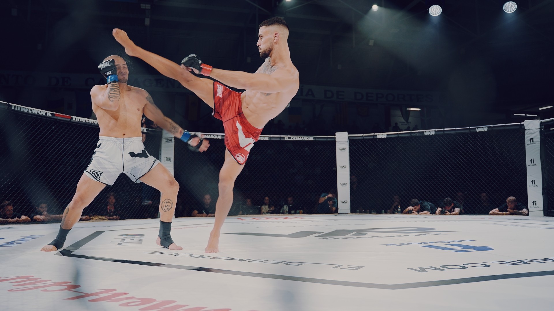Two men wearing yellow and black face masks, standing side by side, with neutral expressions on their faces.