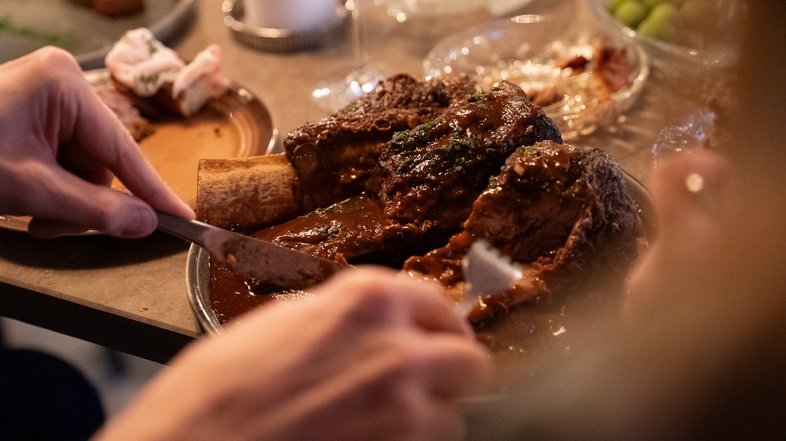 A black-and-white profile of a young man with a mustache in a plaid shirt