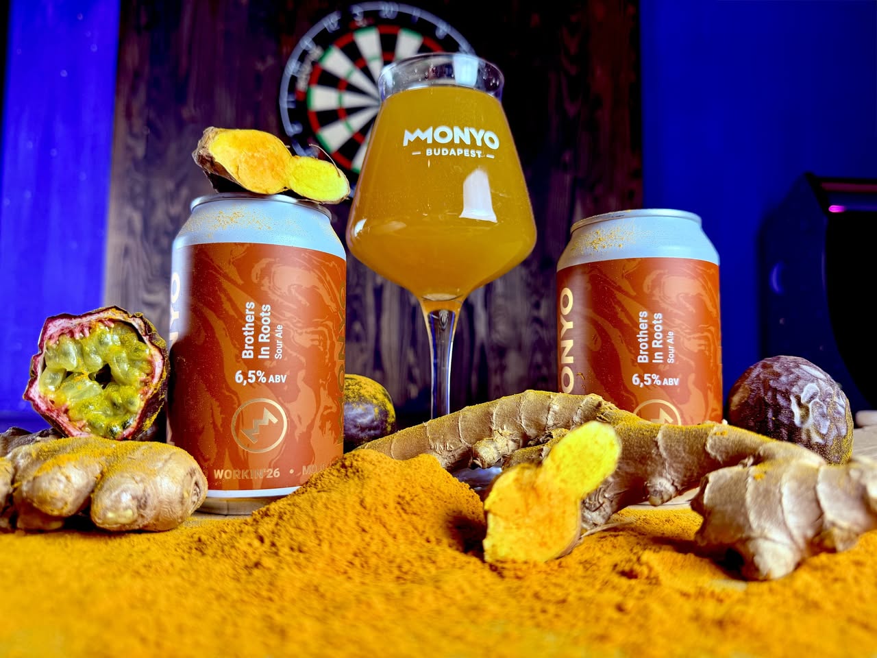 two cans and one glass of MONYO craft beer with ginger and turmeric