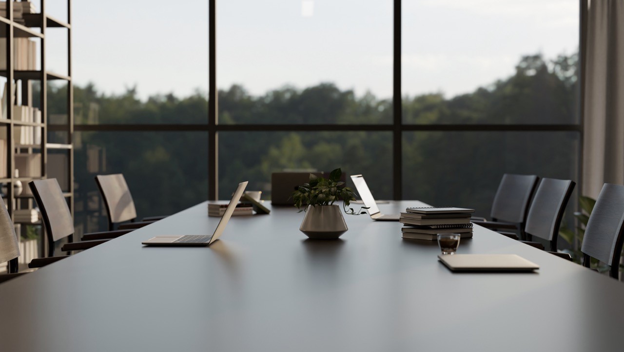 A modern, well-lit boardroom with a large conference table, laptops, and documents prepared for a corporate meeting, symbolizing SAA Law's readiness to provide expert corporate legal services.