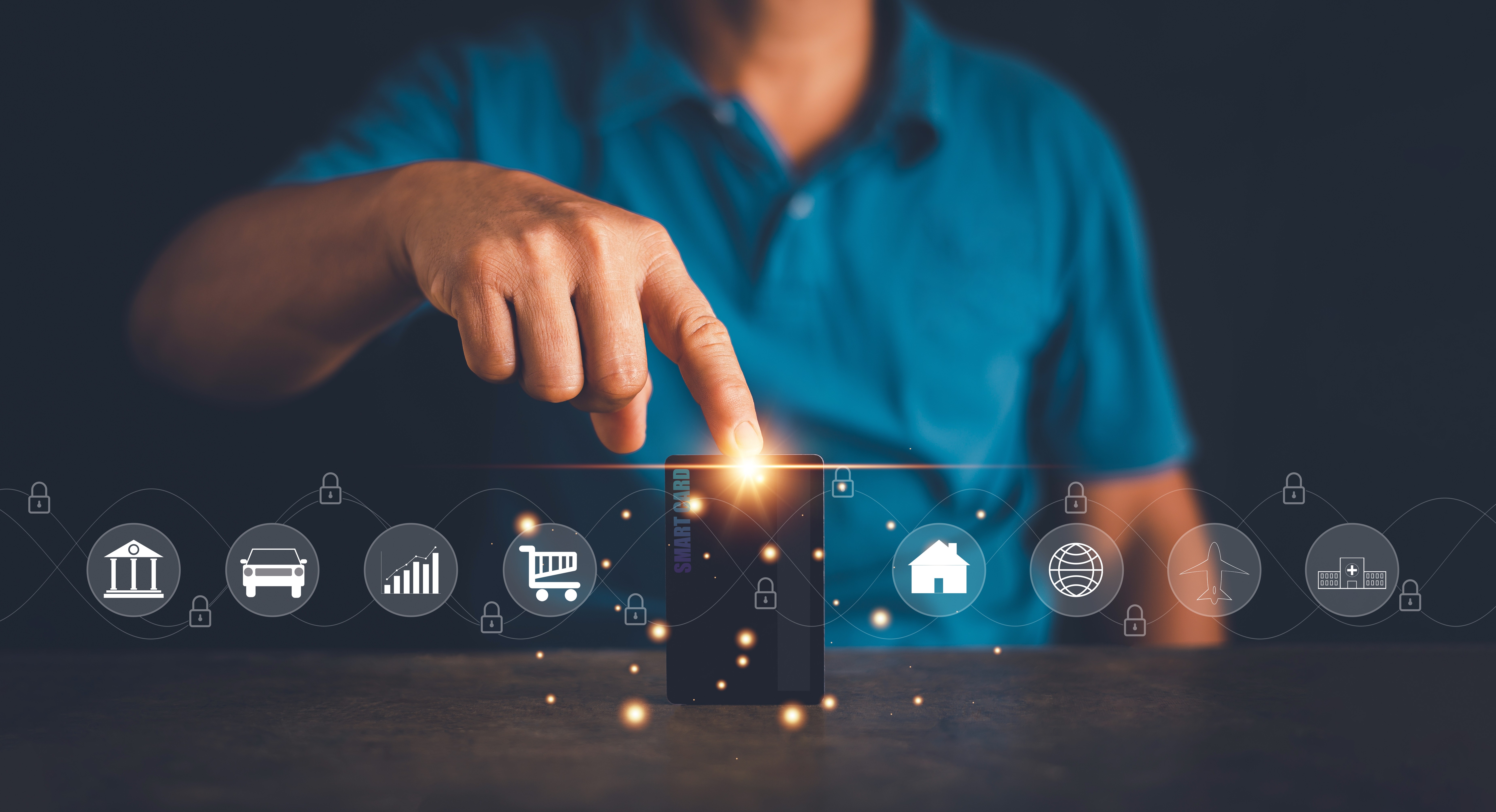 A winding road cuts through rocky terrain, surrounded by patches of green grass and illuminated by sunlight.