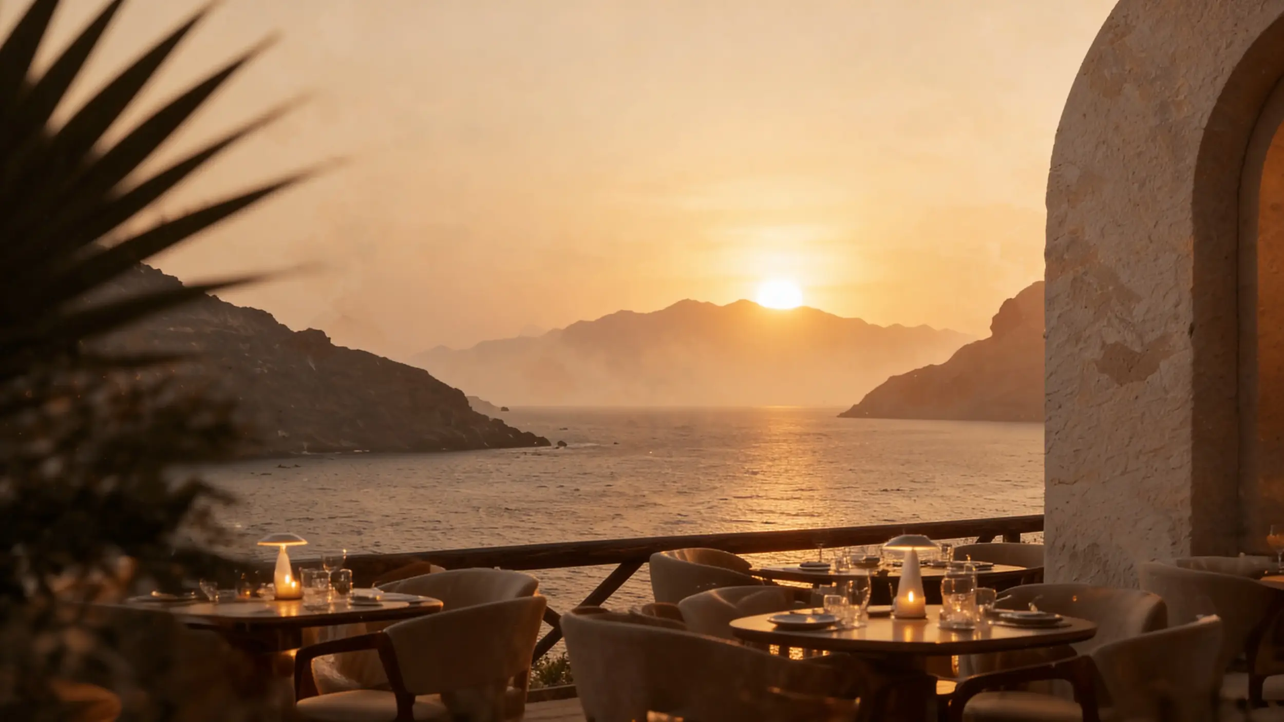 Terrasse méditerranéenne face à la mer au coucher du soleil.