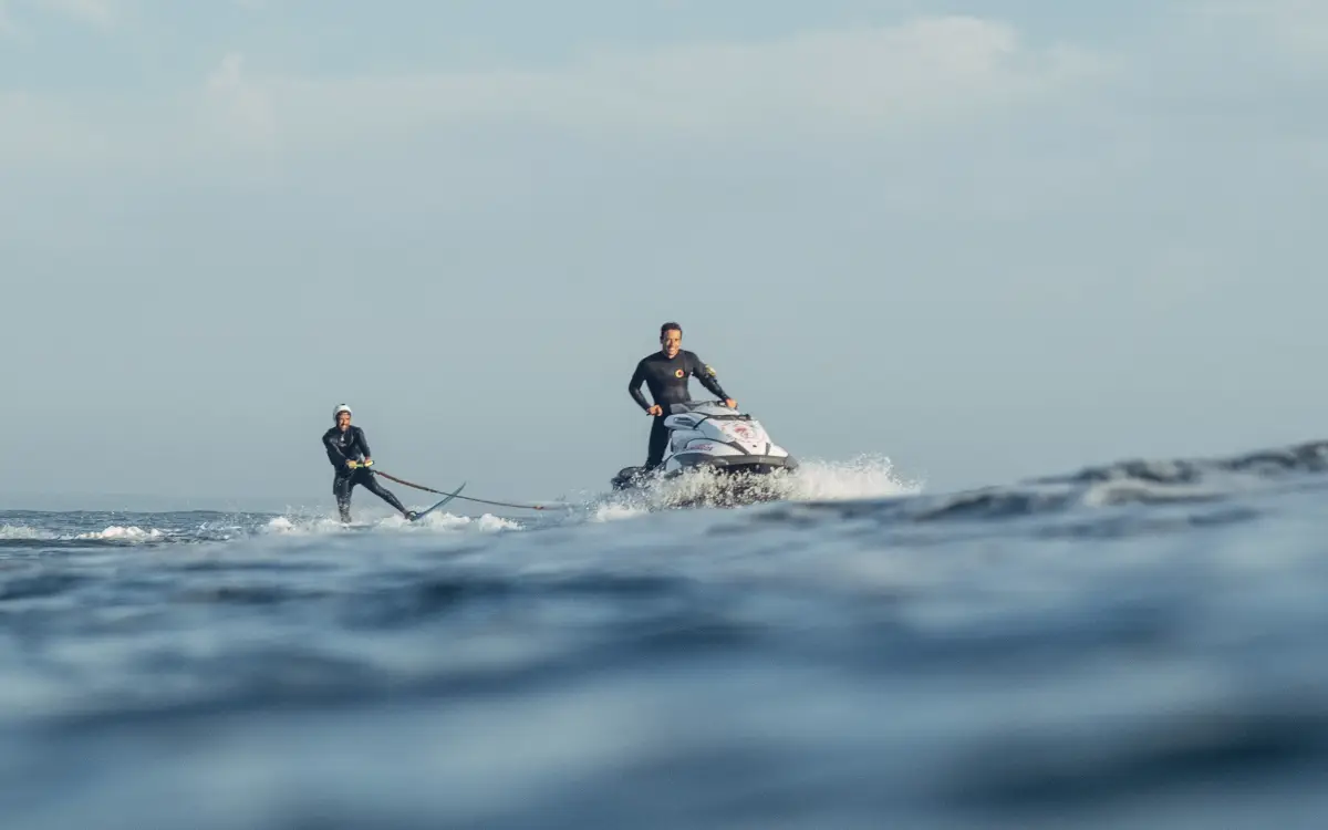 a jet ski dragging a surfer