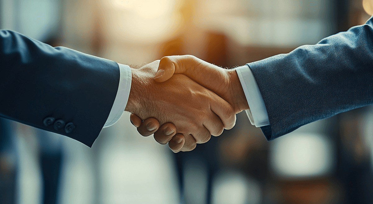 Fireworks illuminate the night sky above a city.