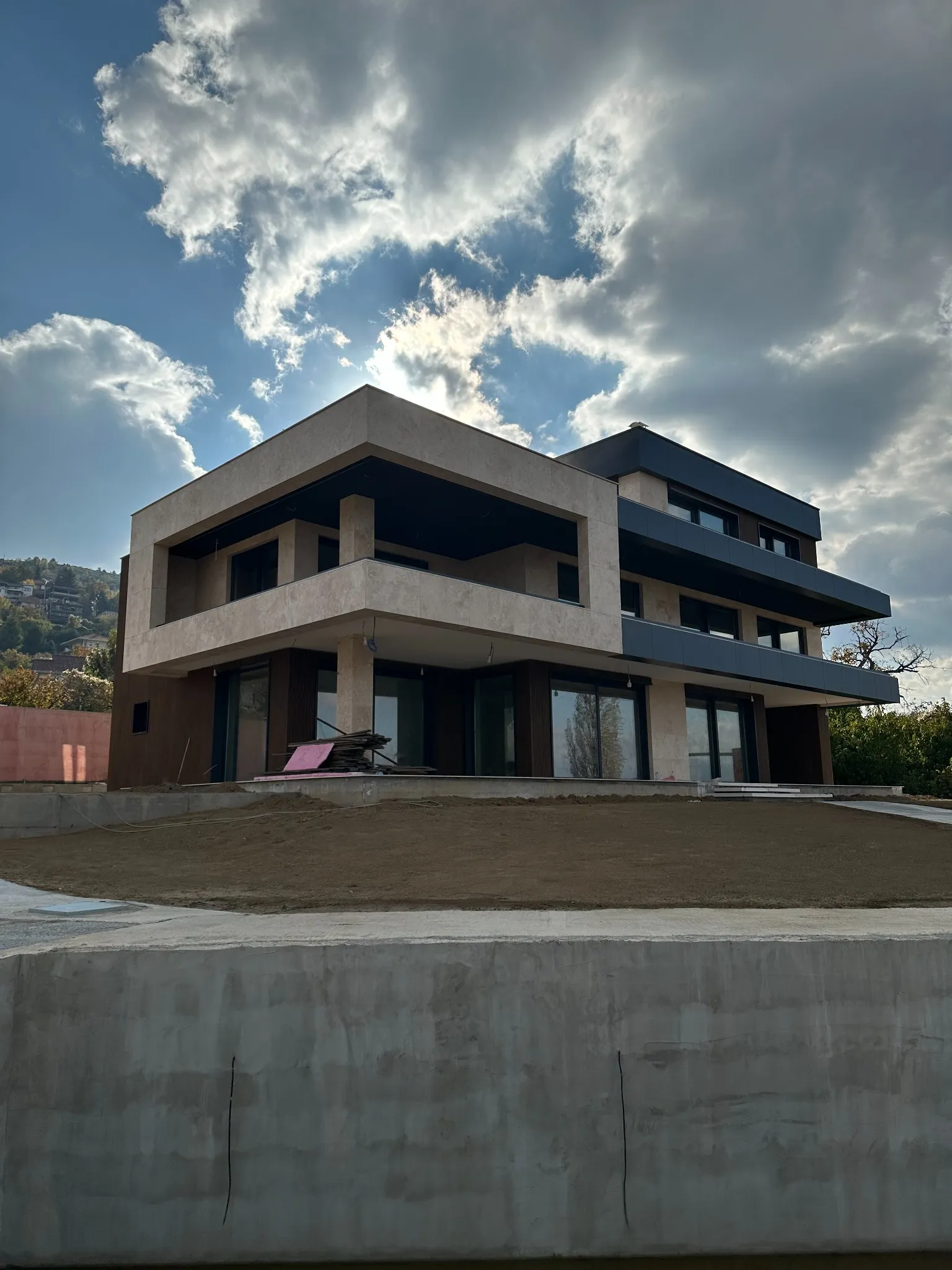 A modern multi-level residence named Villa Nerezi in Nerez, Skopje, designed with strong geometric lines, large terraces, and expansive glazing. Architectural planning and supervision by Terraplan Partners.