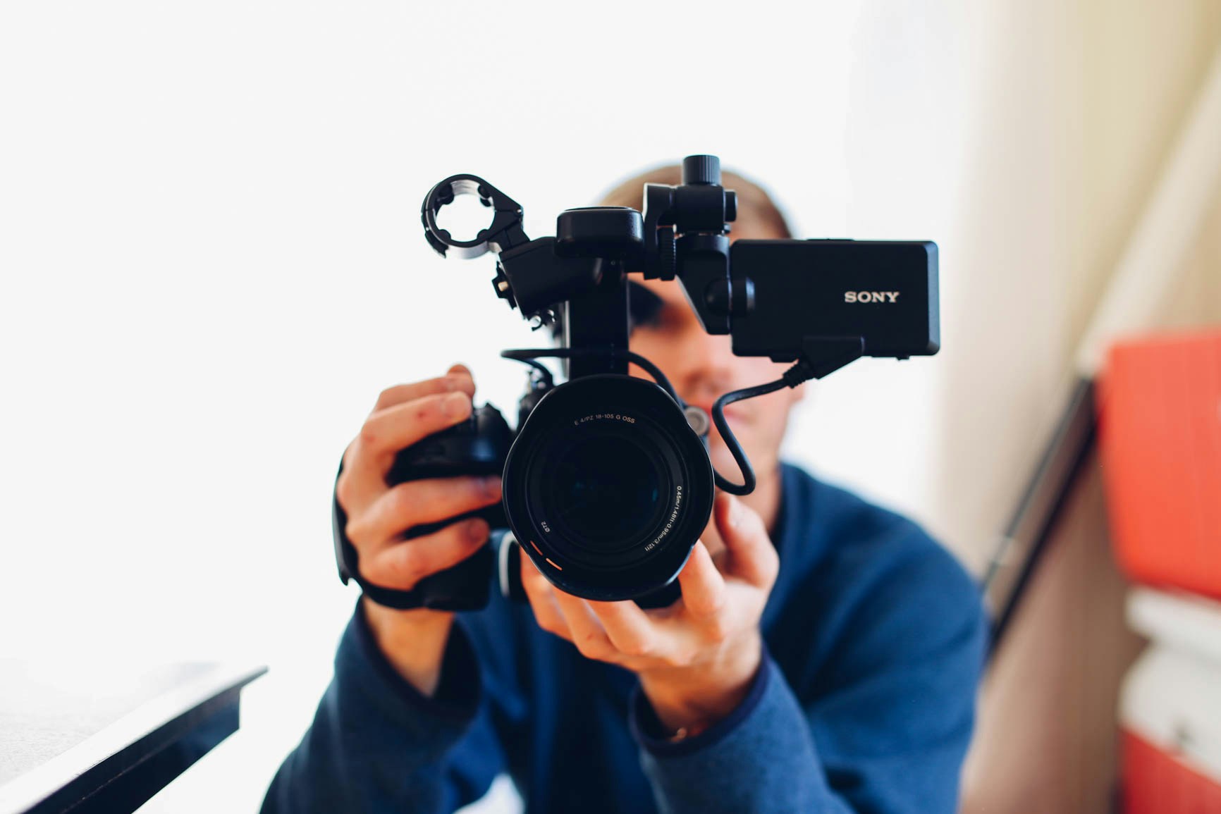 Man holding a camera filming