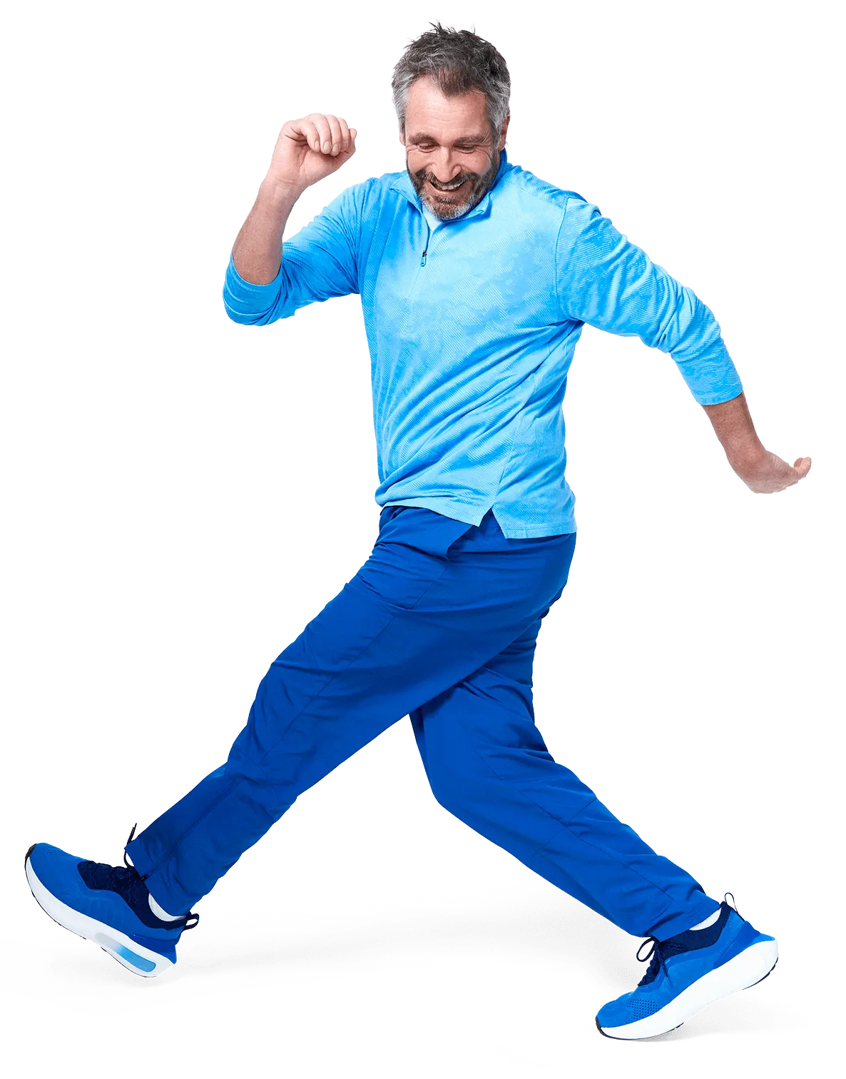 A joyful man in a blue outfit energetically walks with a cheerful expression, capturing a sense of movement.