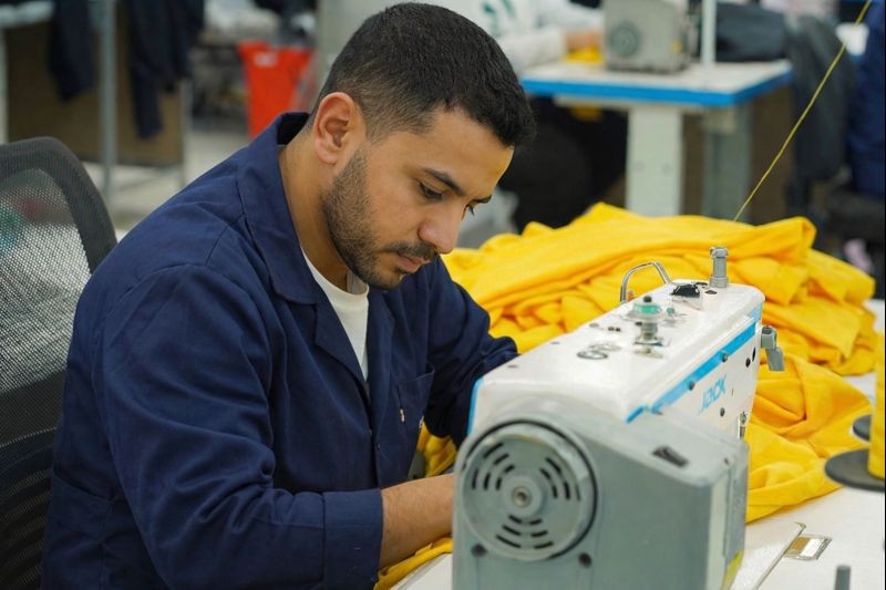 employee who works on the knitting machine.