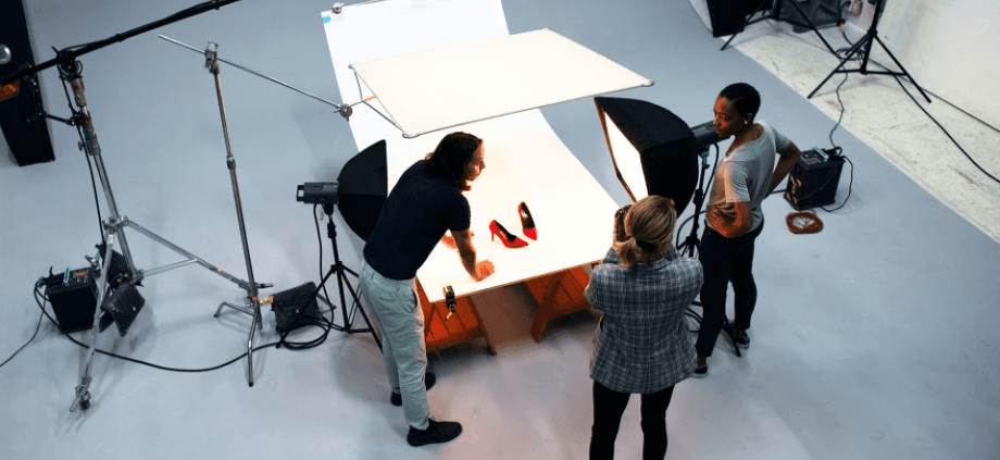 a team taking product photos of a red pair of shoes