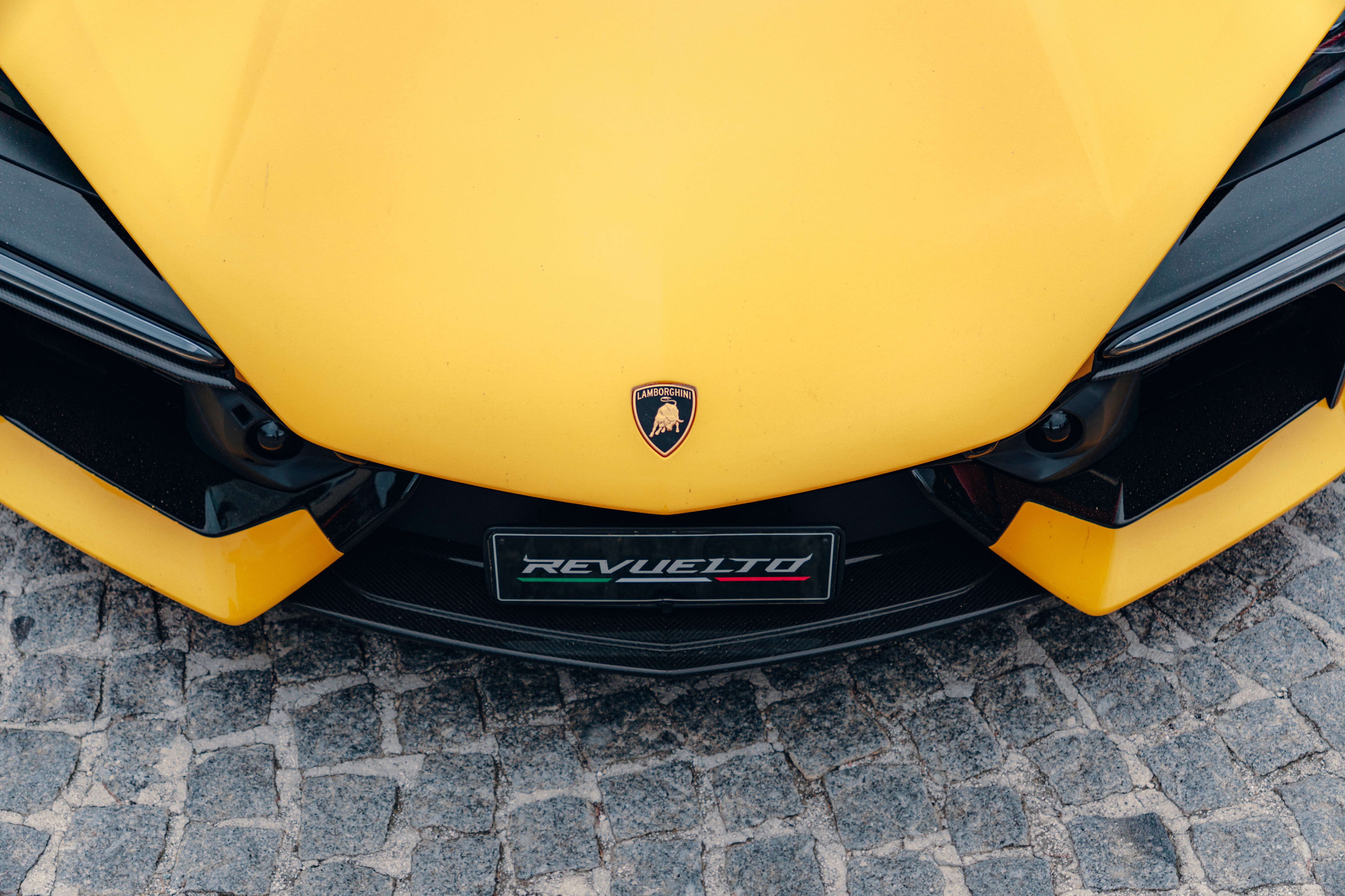 Woman with closed eyes is surrounded by vibrant, colorful, flowing fabric creating an artistic, dreamy effect.