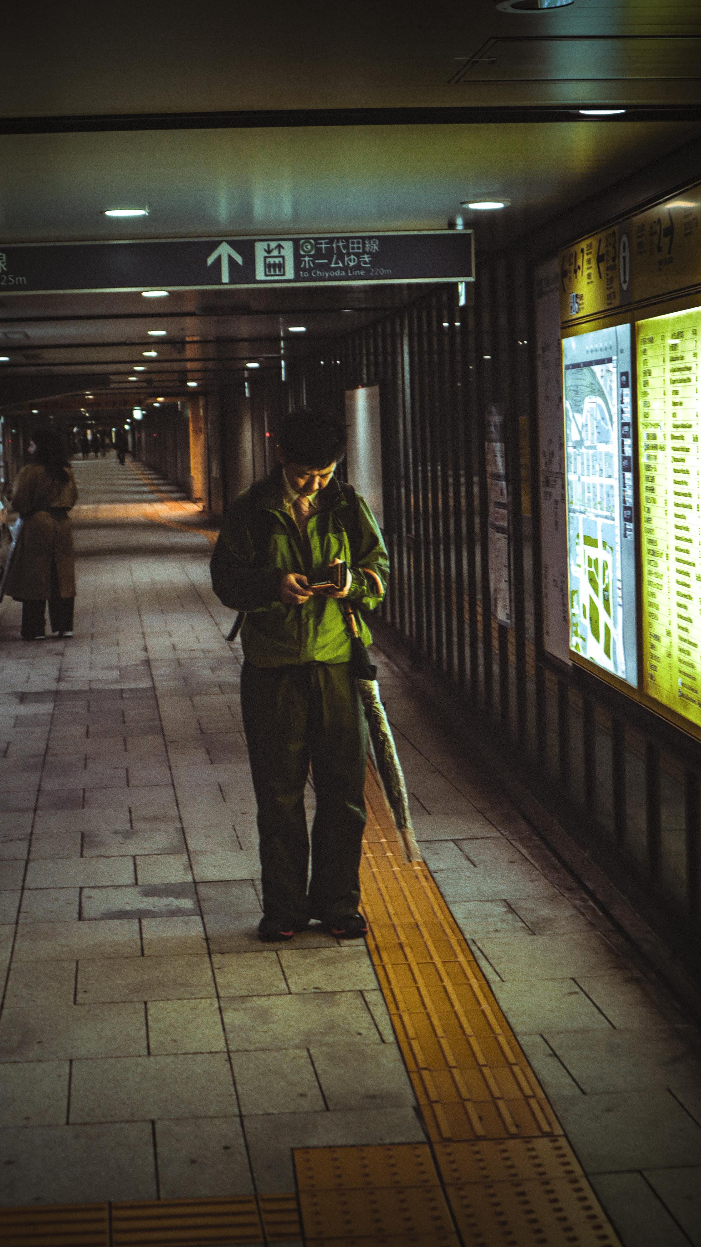 man walking through tokyo subway station