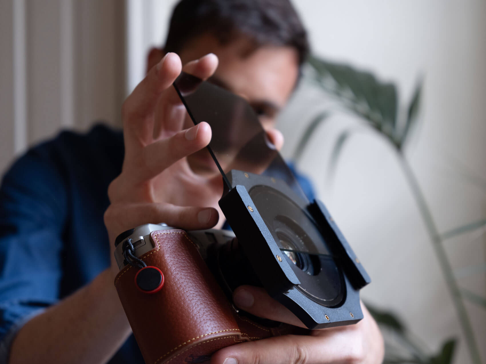 Photographer with a Fuji TX 1 with a filter in front of its lens for ND filters photography