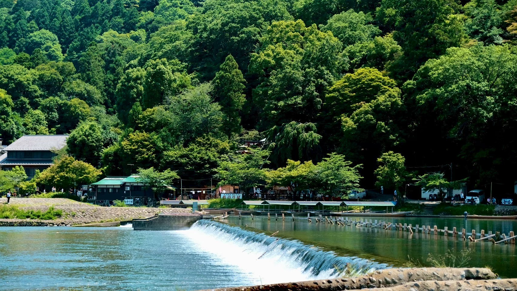 Two people talking on a rooftop at sunset