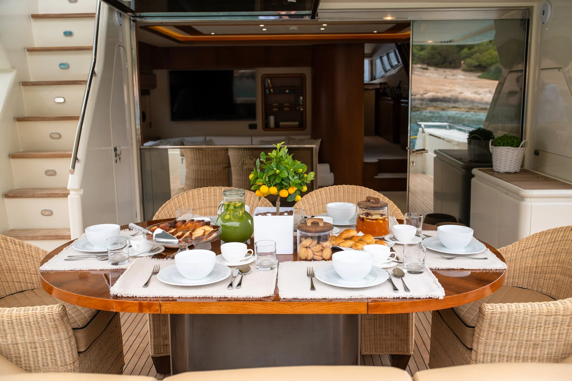 White Rock 36 speedboat with captain at helm cruising calm blue waters near Paros coastline with hills in background.
