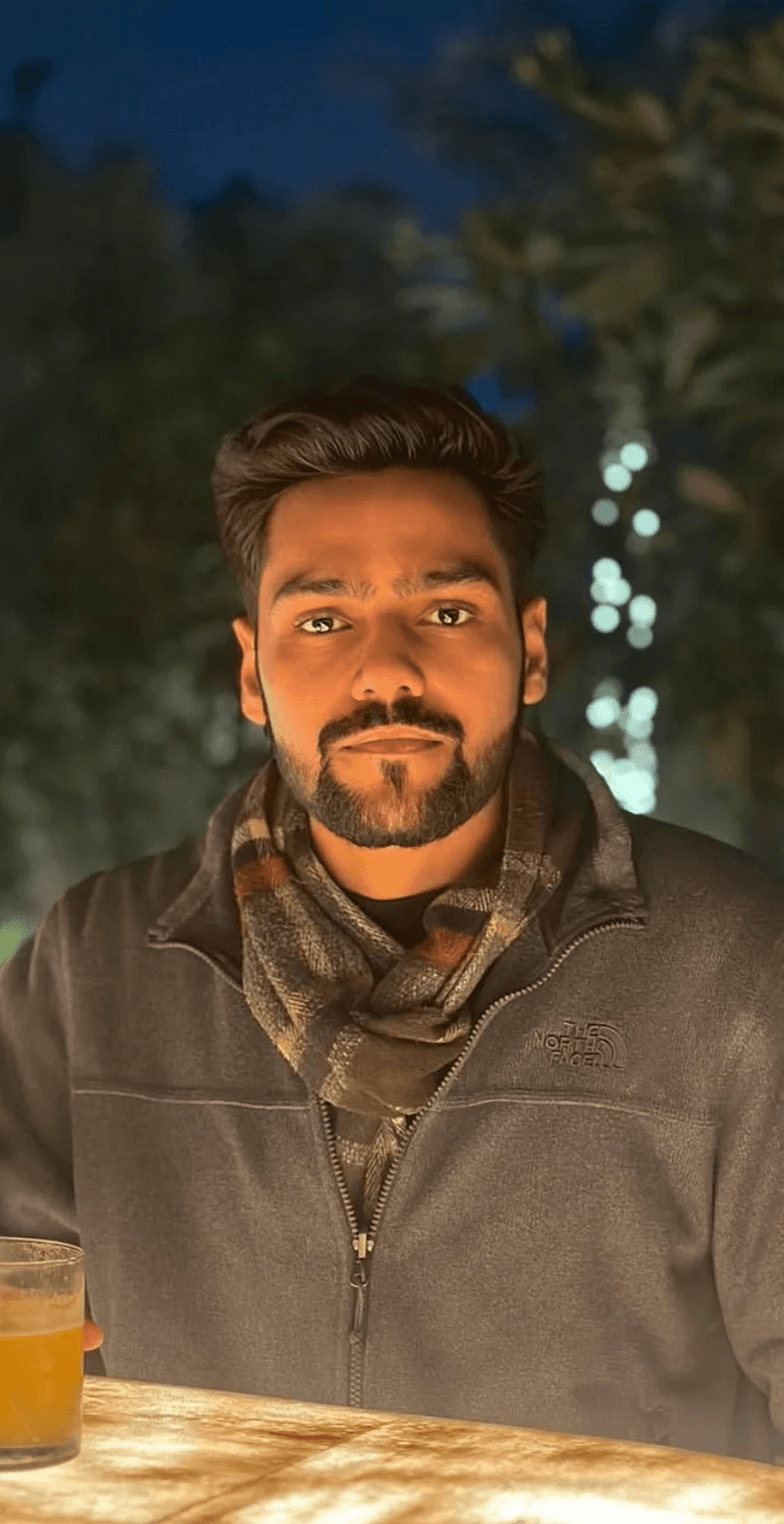 Portrait of a laughing person with curly hair wearing a white shirt
