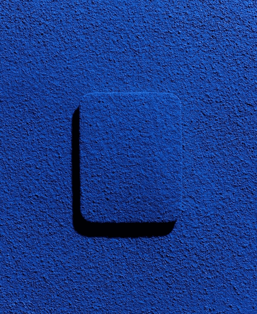 a blurry photo of a person standing in front of a wall