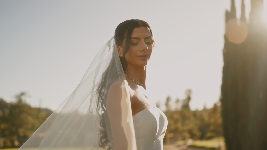 The bride is putting on her earrings.