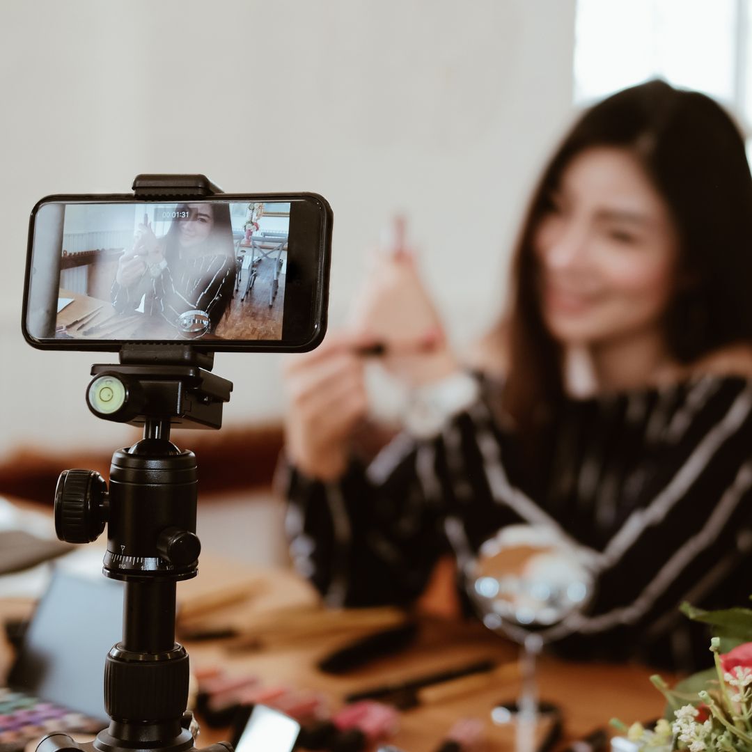 person using both laptop and smartphone