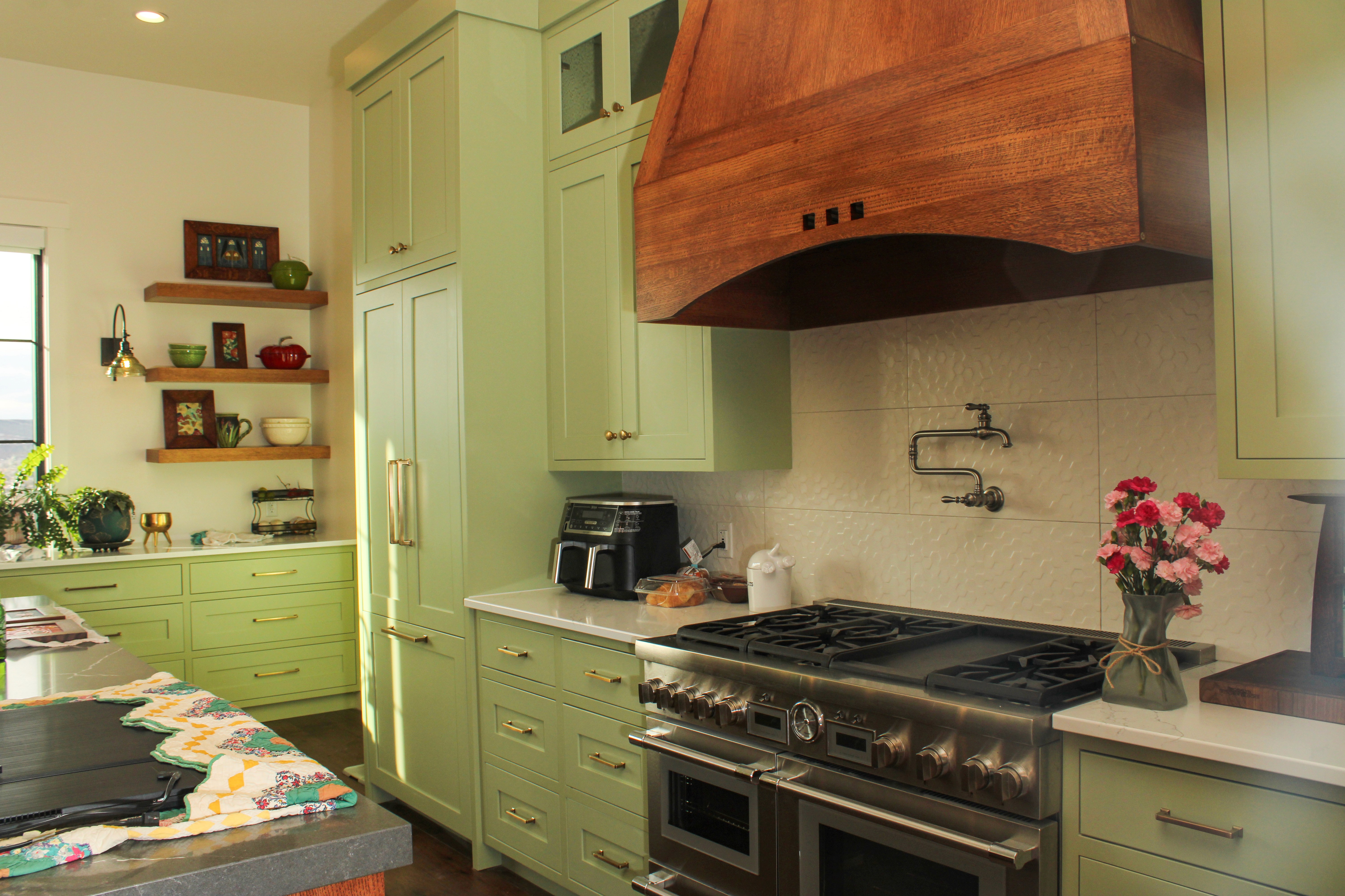 St. George Utah kitchen remodel showing oven with natural wood hood and green cabinetry