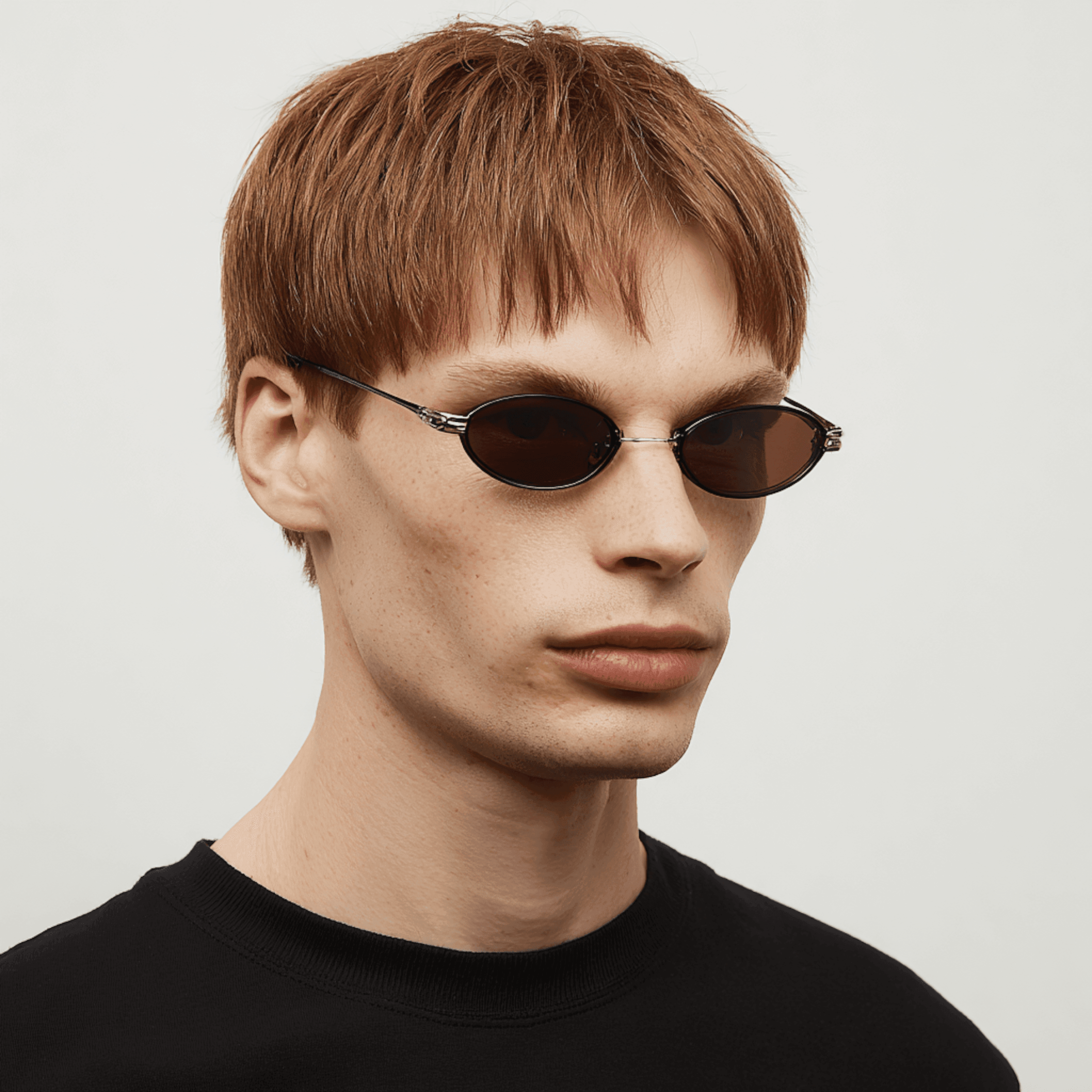 Close-up portrait of a man with glossy red sunglasses