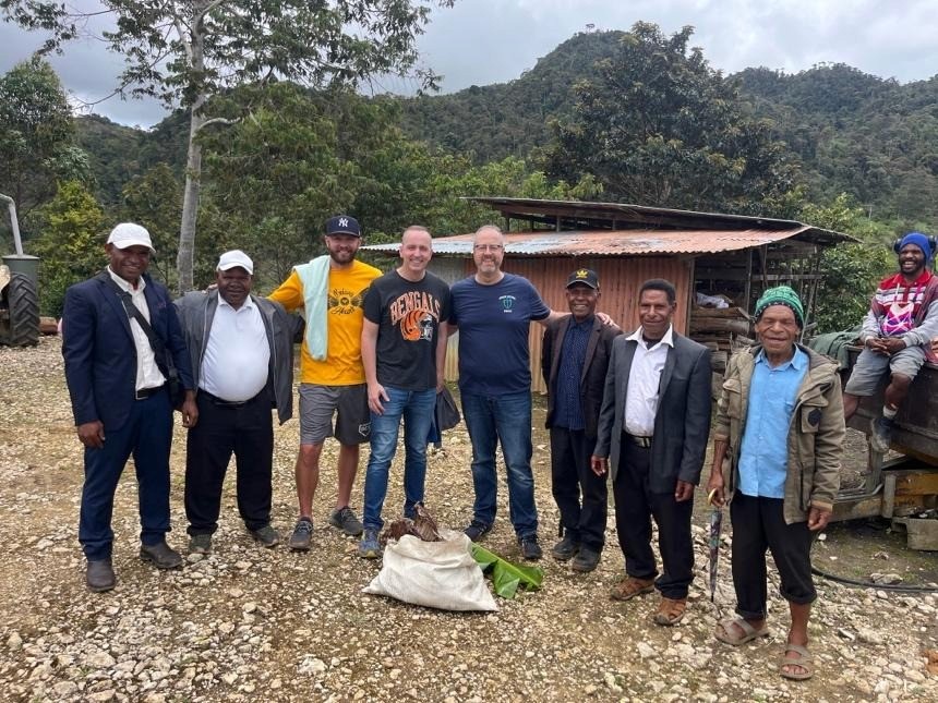A group of men standing in front of a shack

AI-generated content may be incorrect.