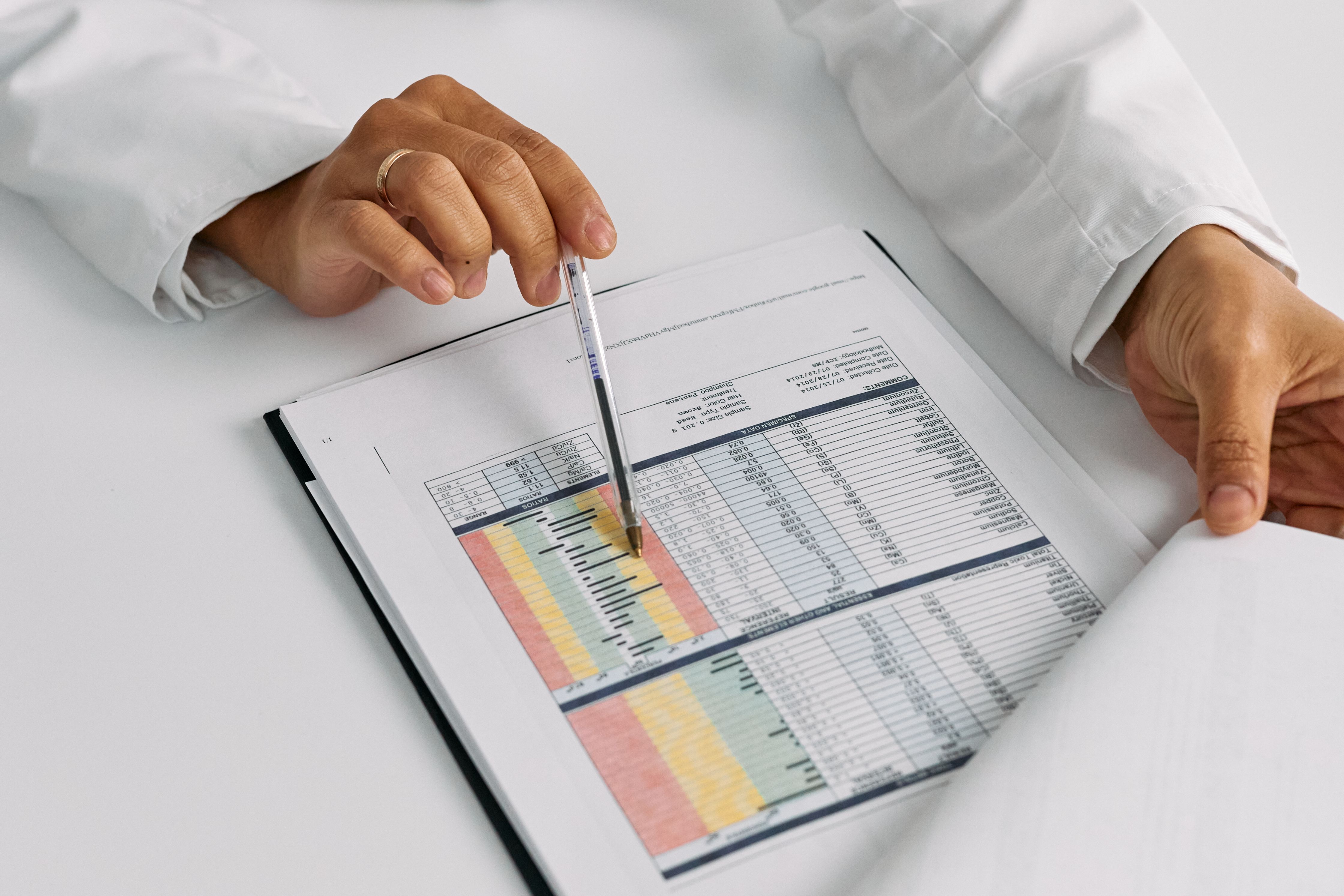 doctor-hands-examining-and-pointing-at-medical-charts-in-a-close-up-view. - cottonbro-studio (pexels)