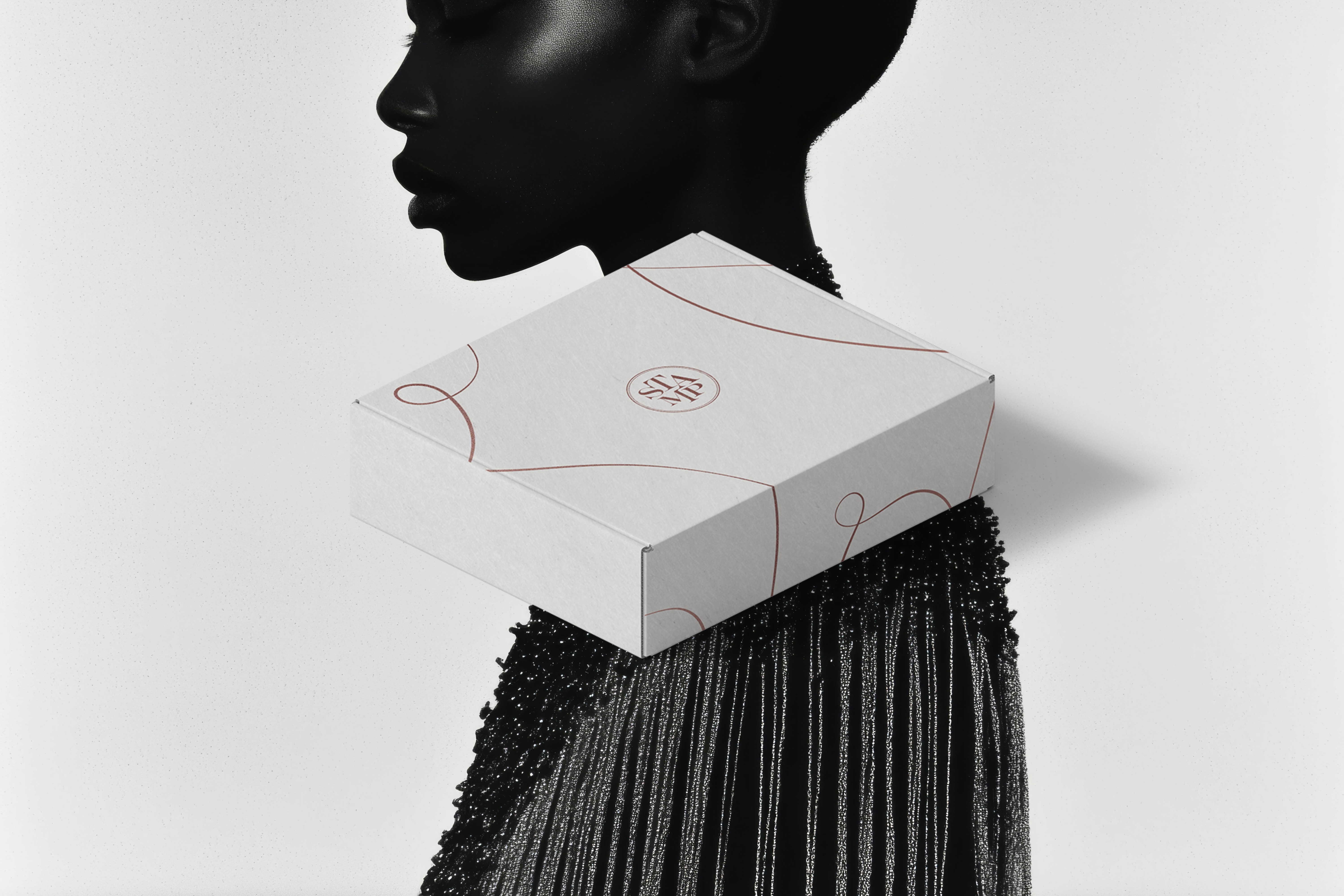  A sleek packaging box with STAMP’s refined branding, resting gracefully on a model’s shoulder, complementing her dazzling black attire.
