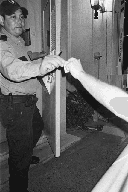 handing the neighborhood guard the ID in monterrey Mexico