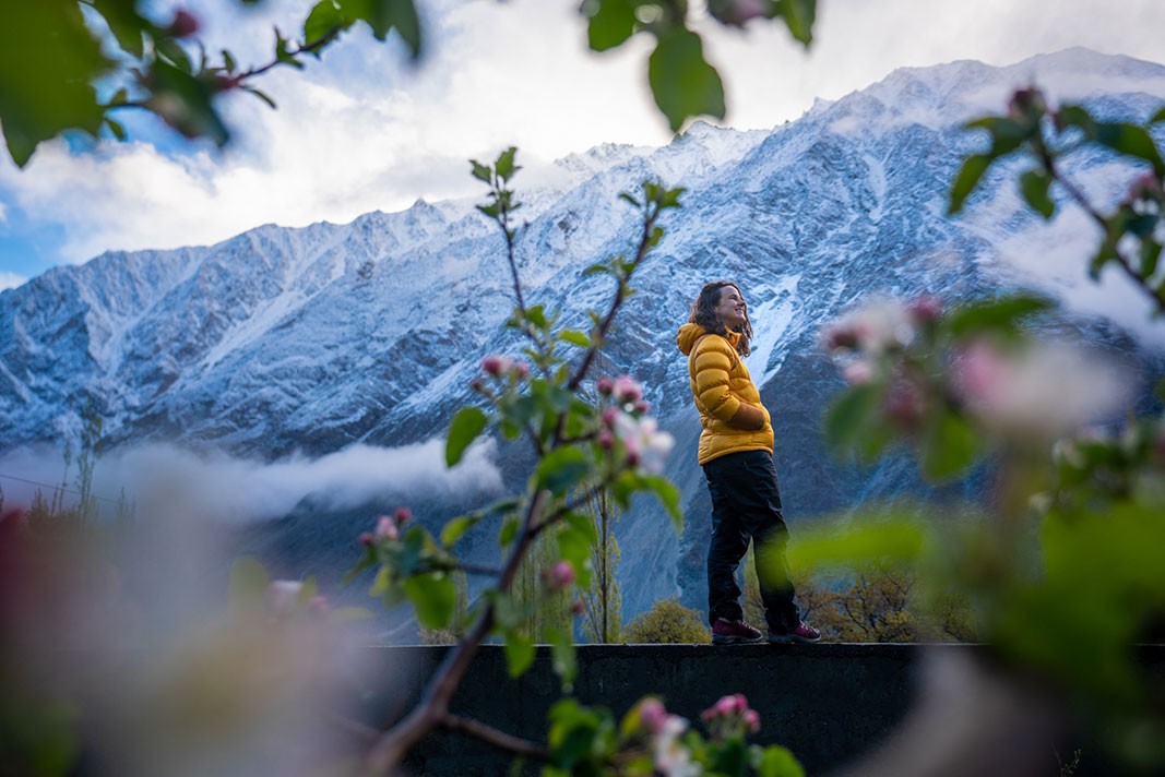 A guest standing and smiling in the mountains of Pakistan