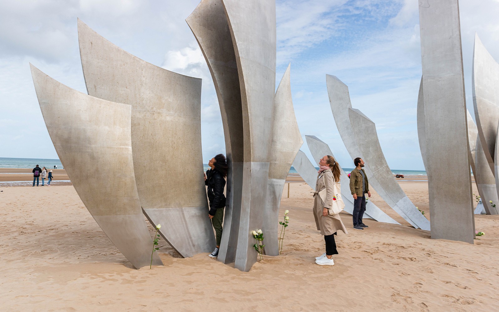 Tour group exploring Les Braves Memorial on Omaha Beach, Normandy.