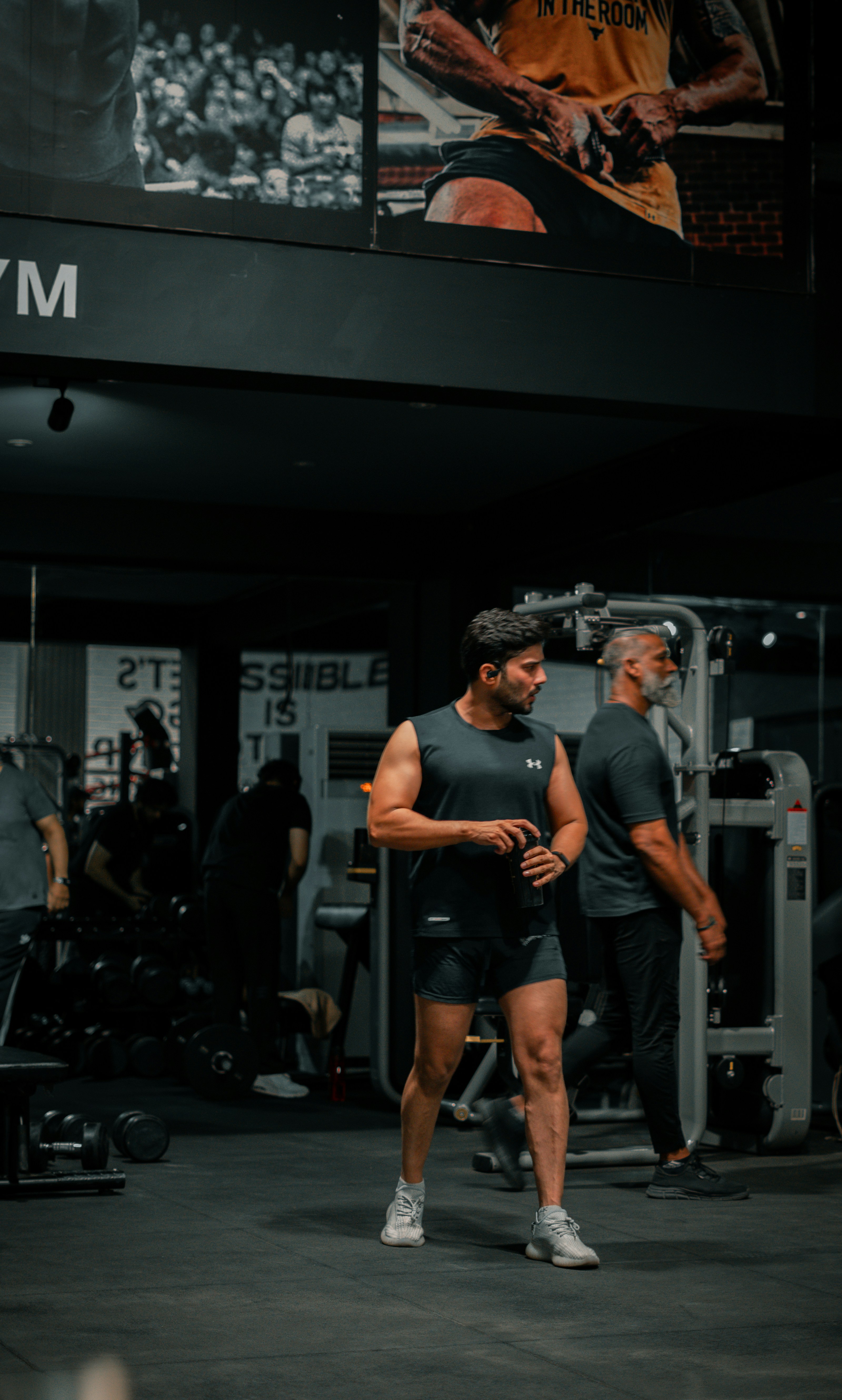 Man stands in gym after his workout.