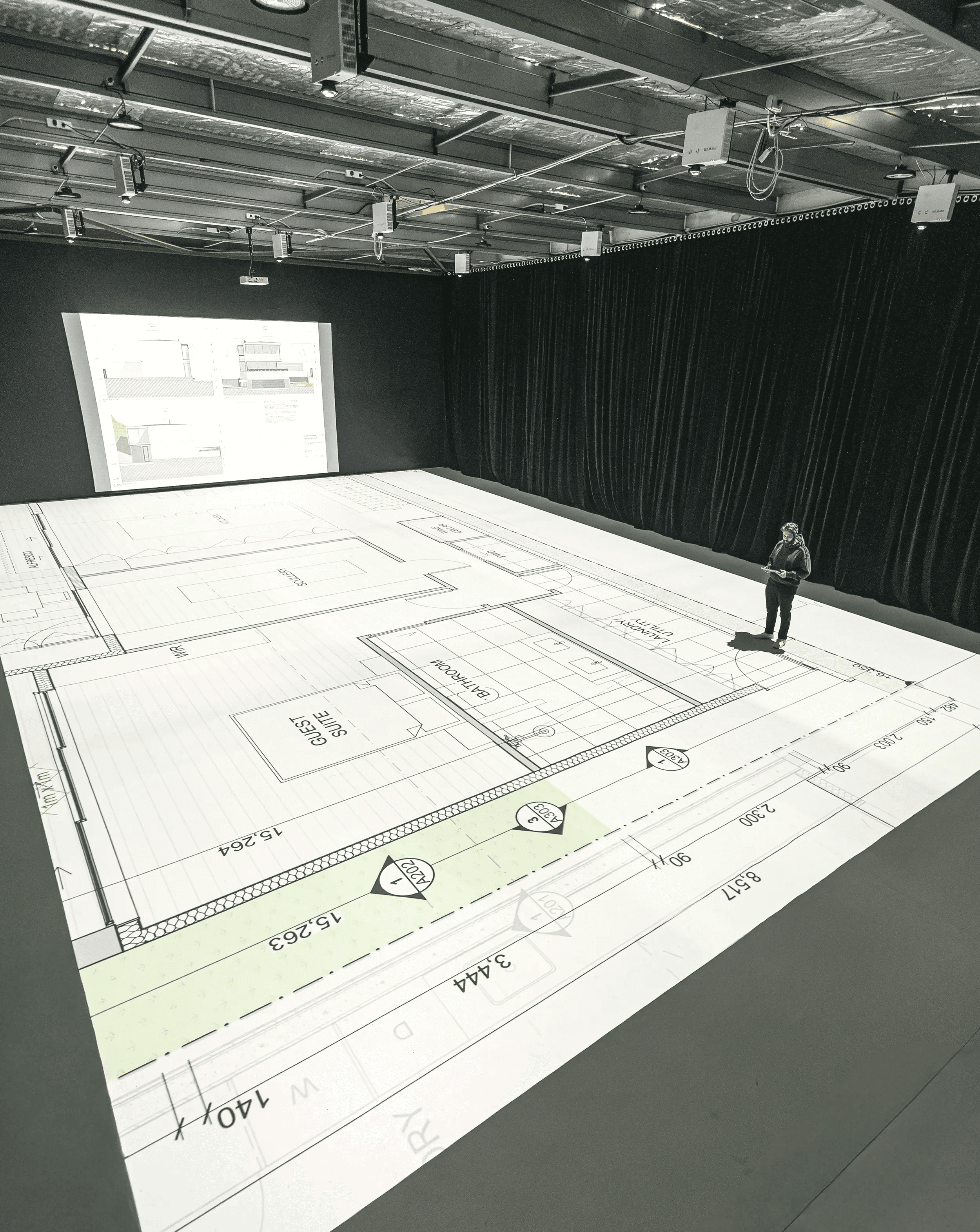 wide angle view of the studio with floorplans being projected