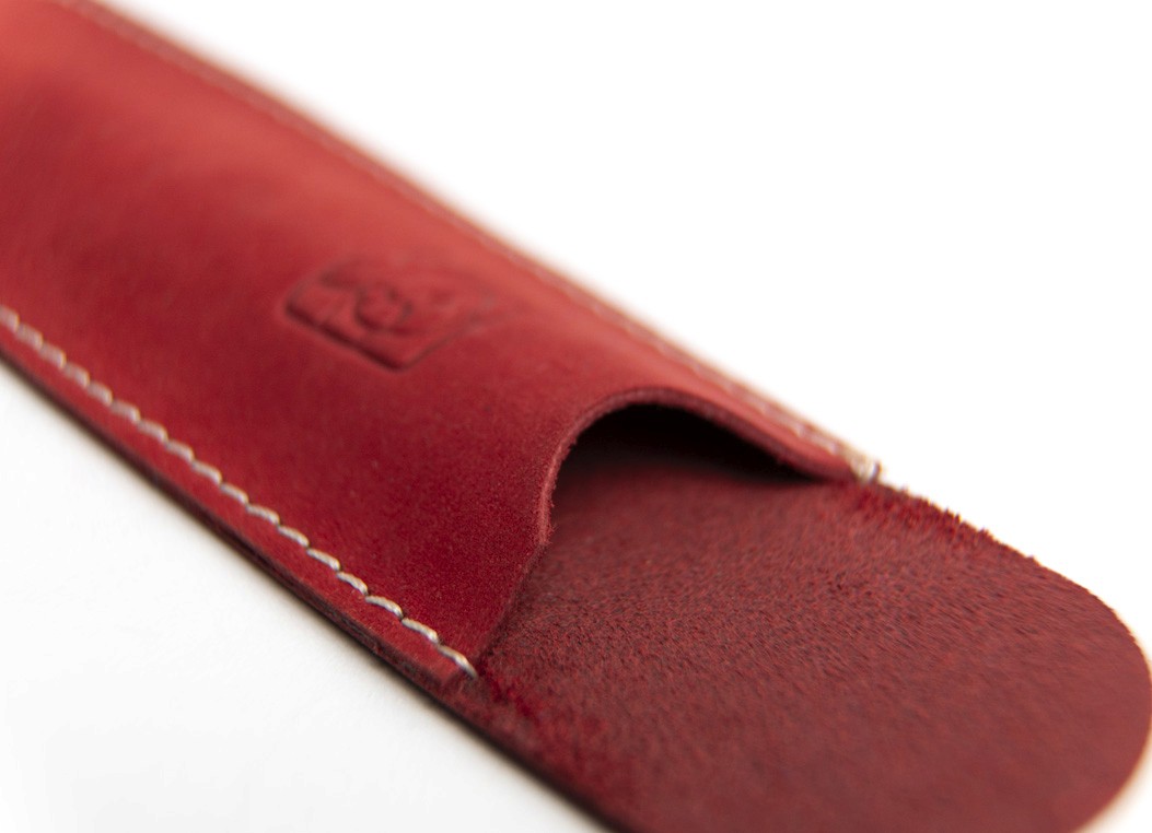 Close-up of the red leather sleeve opening showing the soft texture and stitched edges.