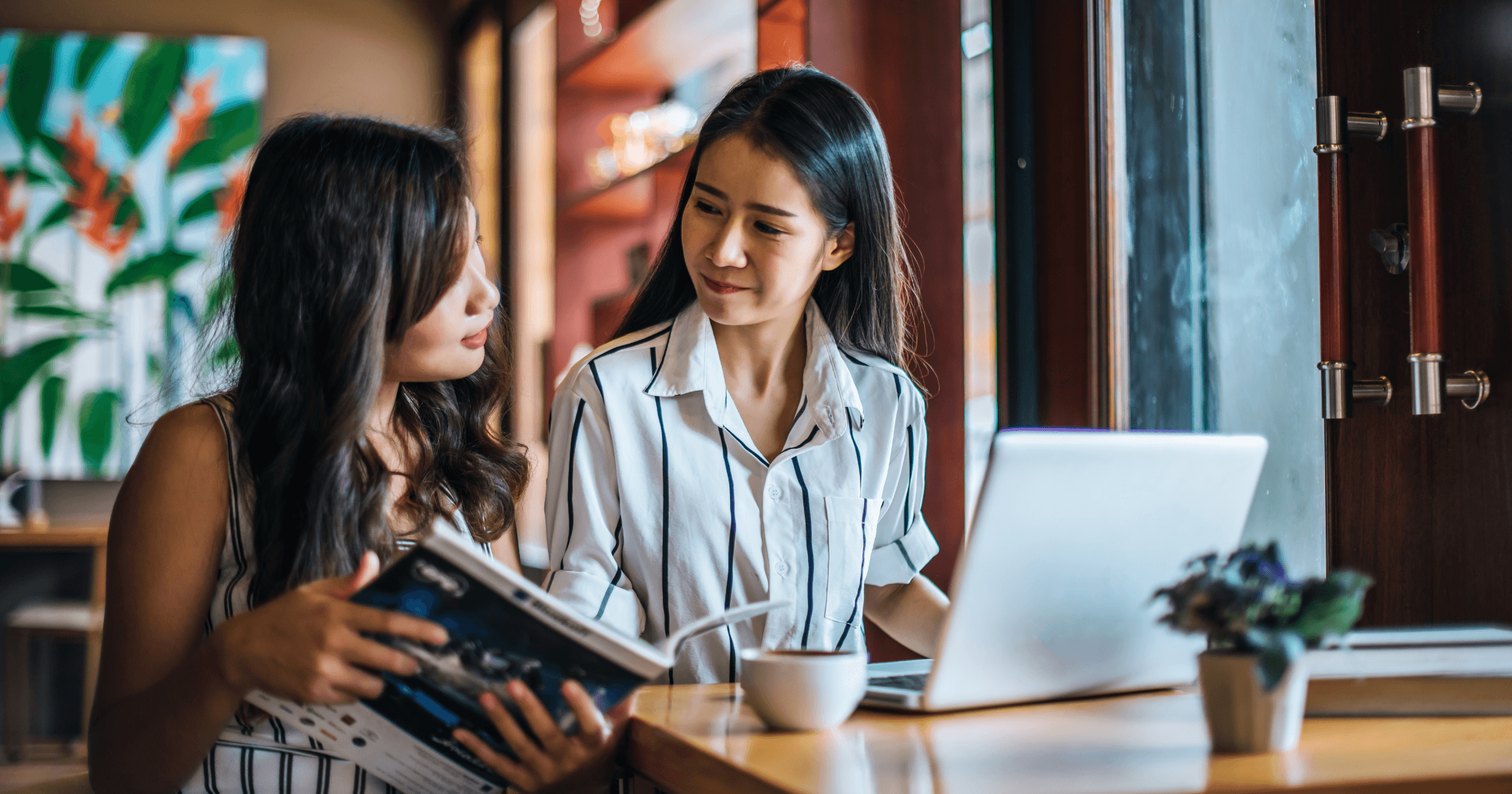 A person talking with an employeee in their cafe