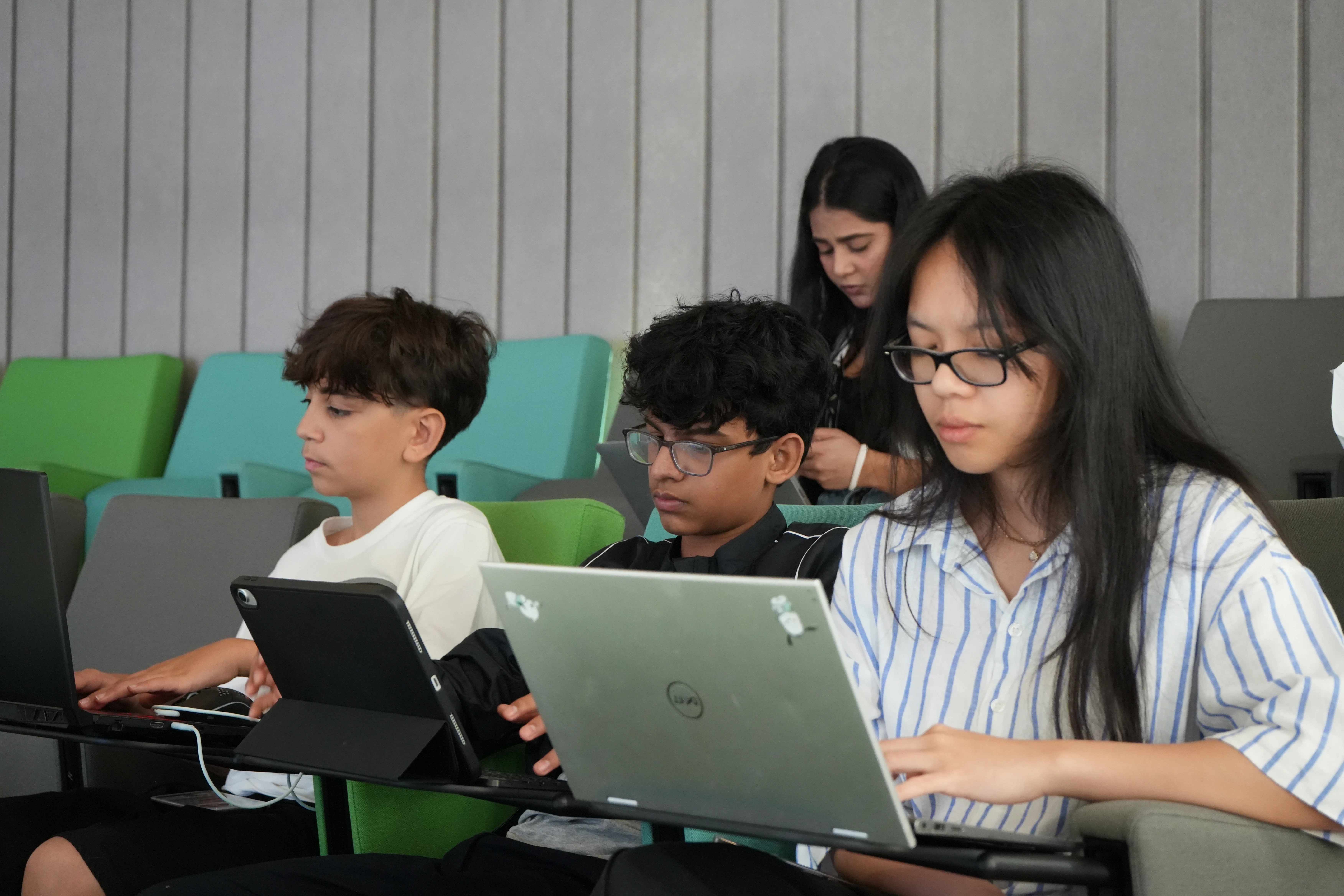 Smiling high school girl engaged in an online tutoring session with her peers at Rise Research