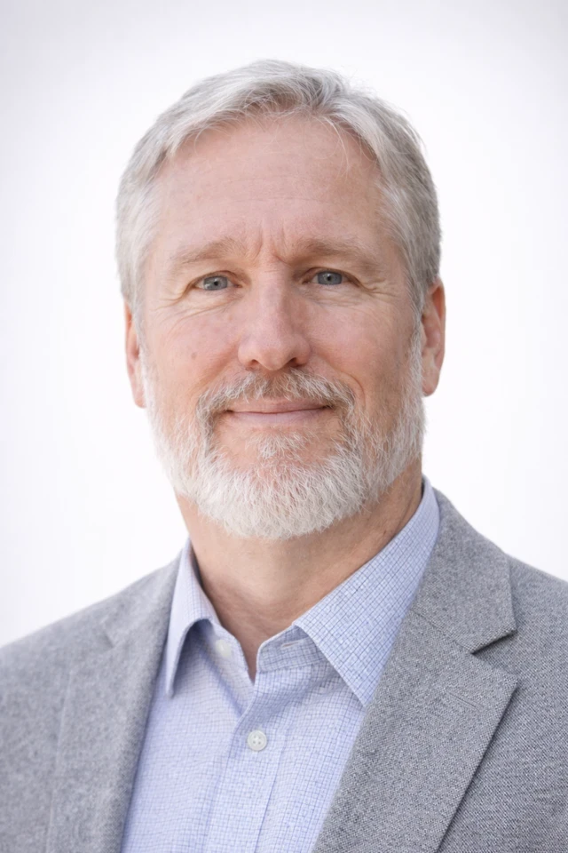 Scientist looking through a microscope in a lab.