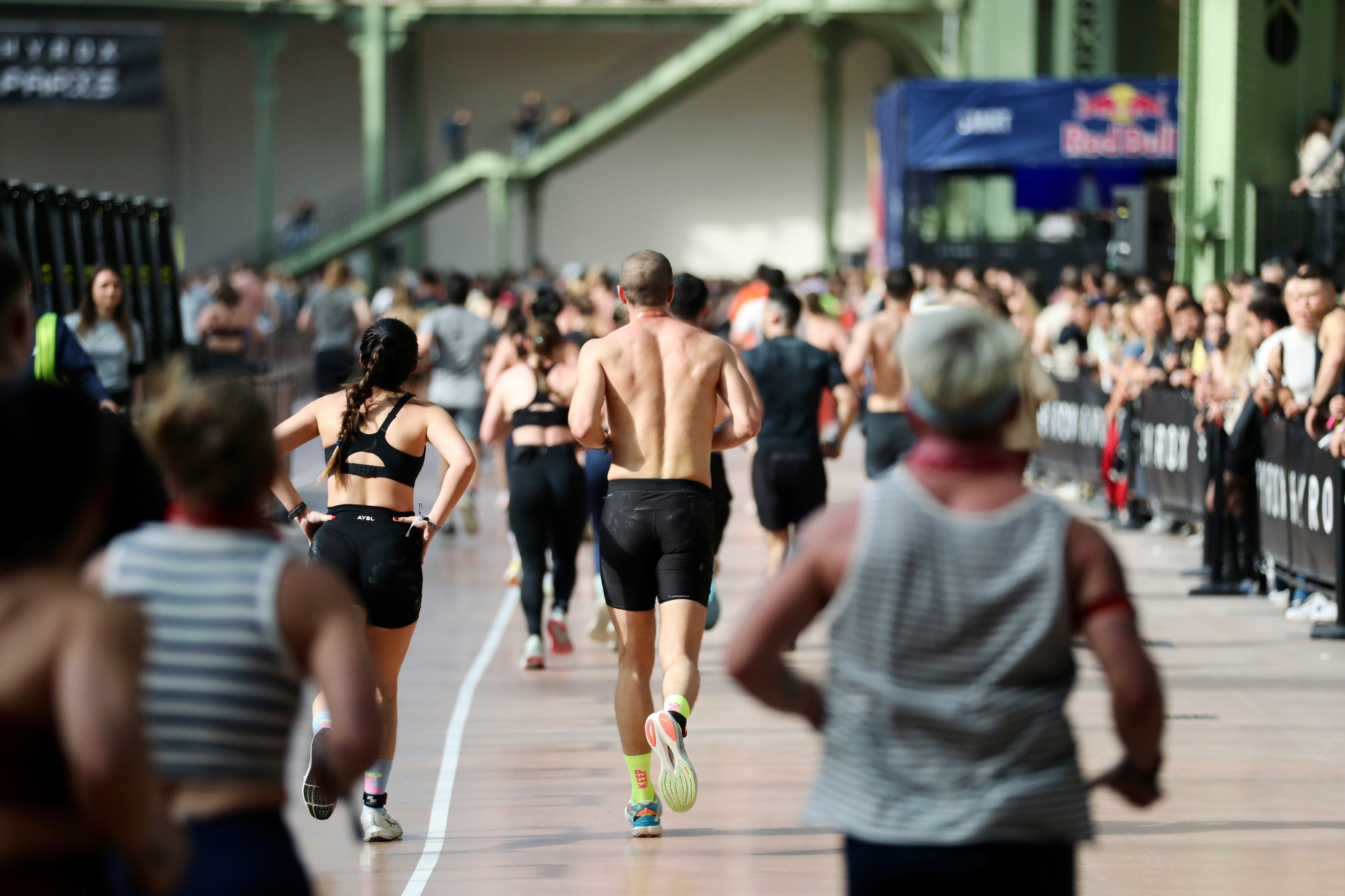 Athletes running in an indoor race event.