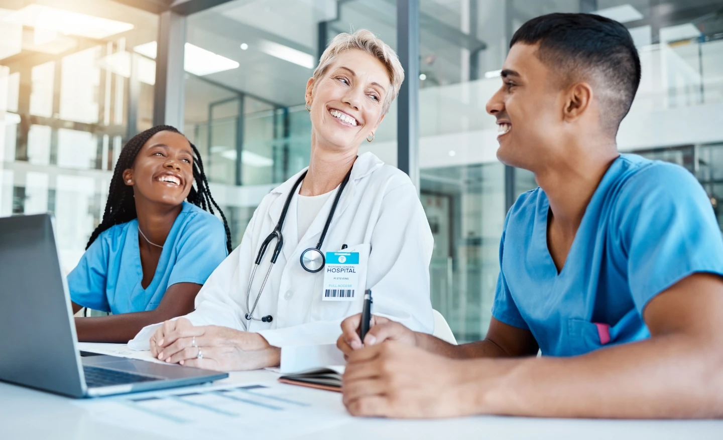 Caucasian female doctor, engaged in a conversation with her young resident doctors.
