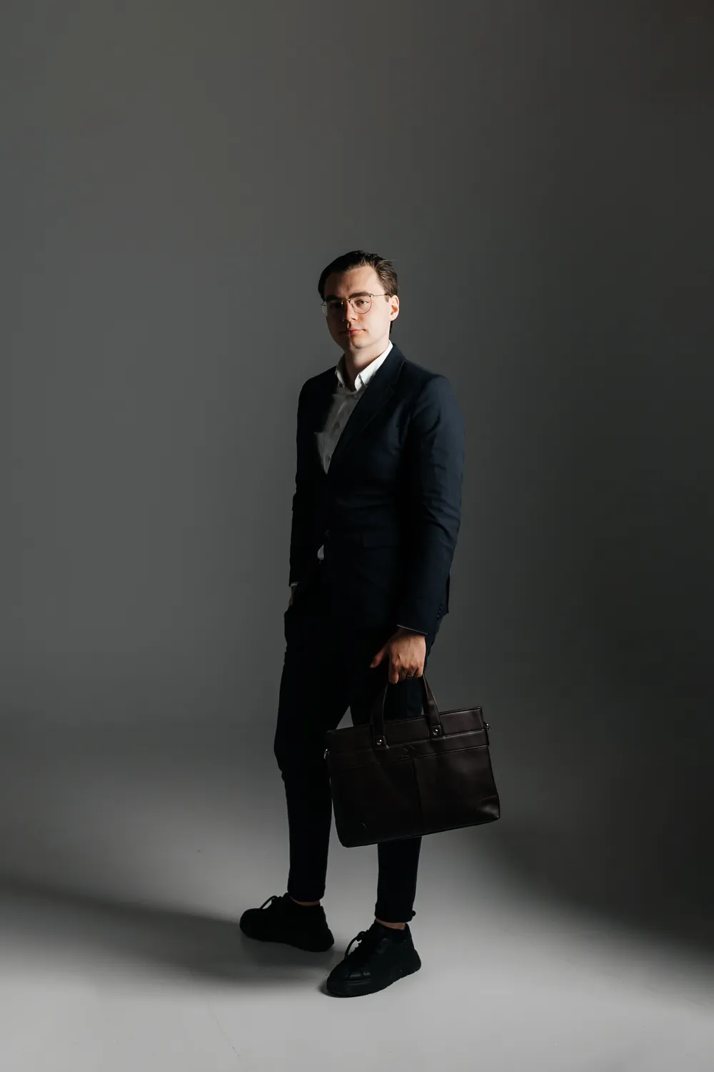 Vytautas (Vytas) Mikulėnas, founder of Lean Sales Systems, in a navy suit with a briefcase