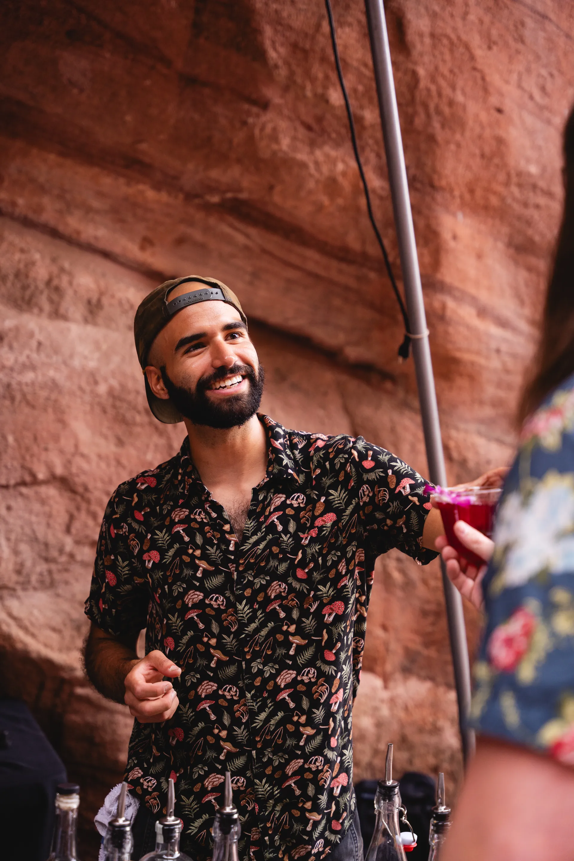 Alex handing an event guest a cocktail