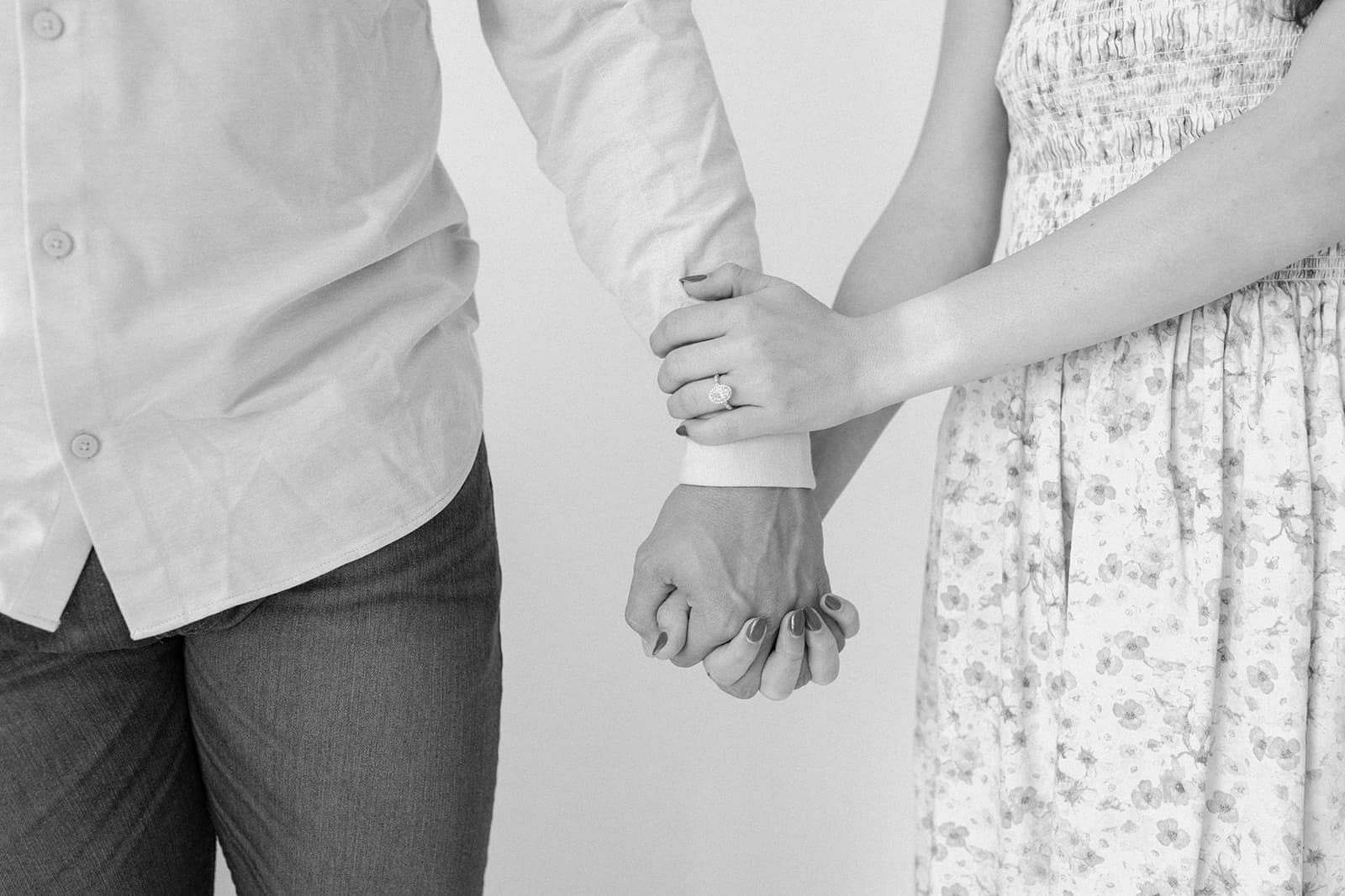 Close-up of the couple’s hands, with an engagement ring visible, at Revelator Studio in Shreveport.