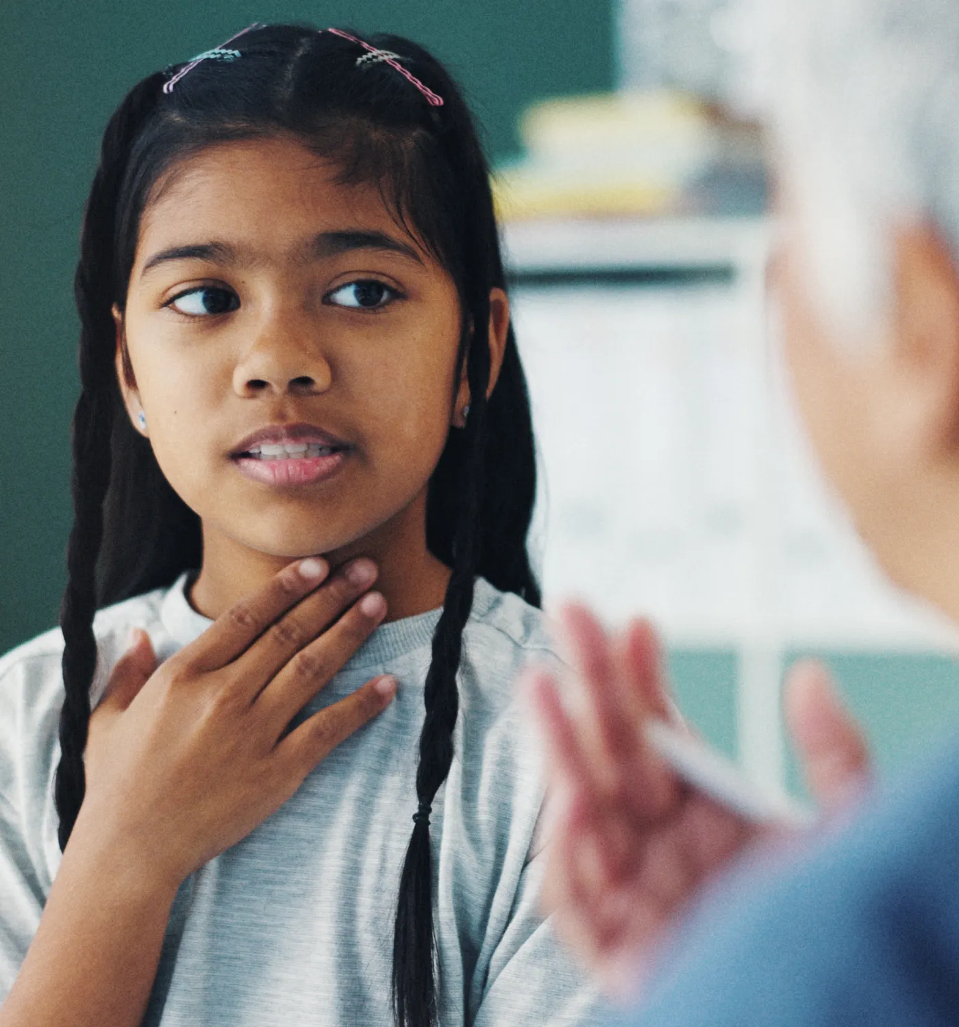 Young girl practicing speech sounds with a pediatric speech therapist
