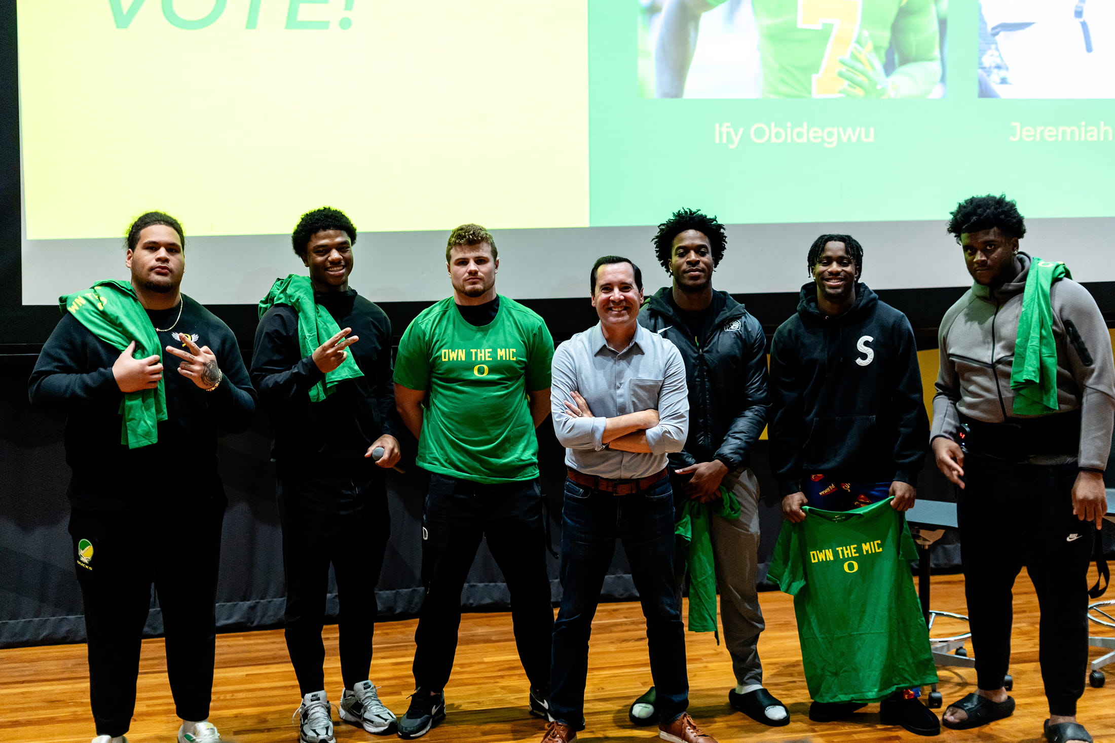 A group of young altheletes smiling with our founder after a workshop