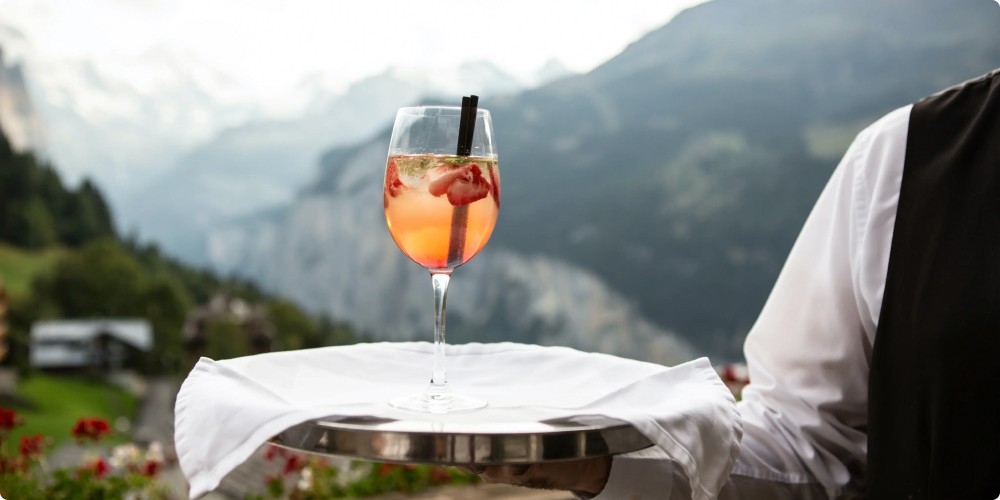 Wine being served on a tray by a waiter