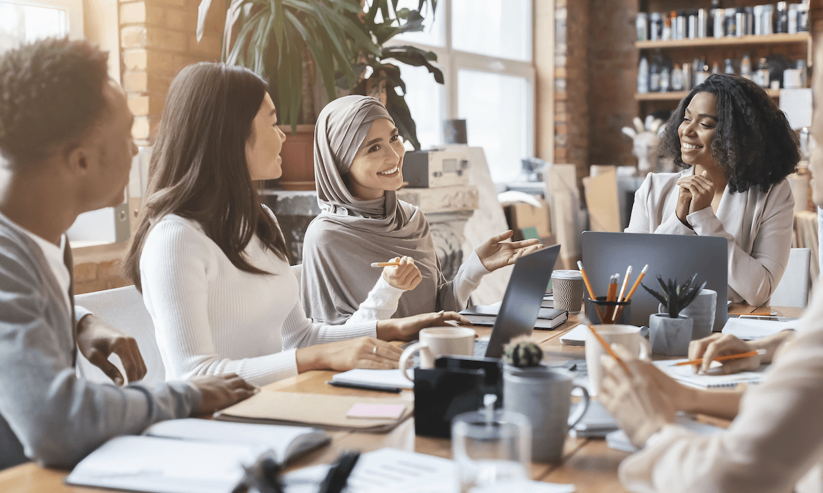 cross functional team: Teammates having a meeting