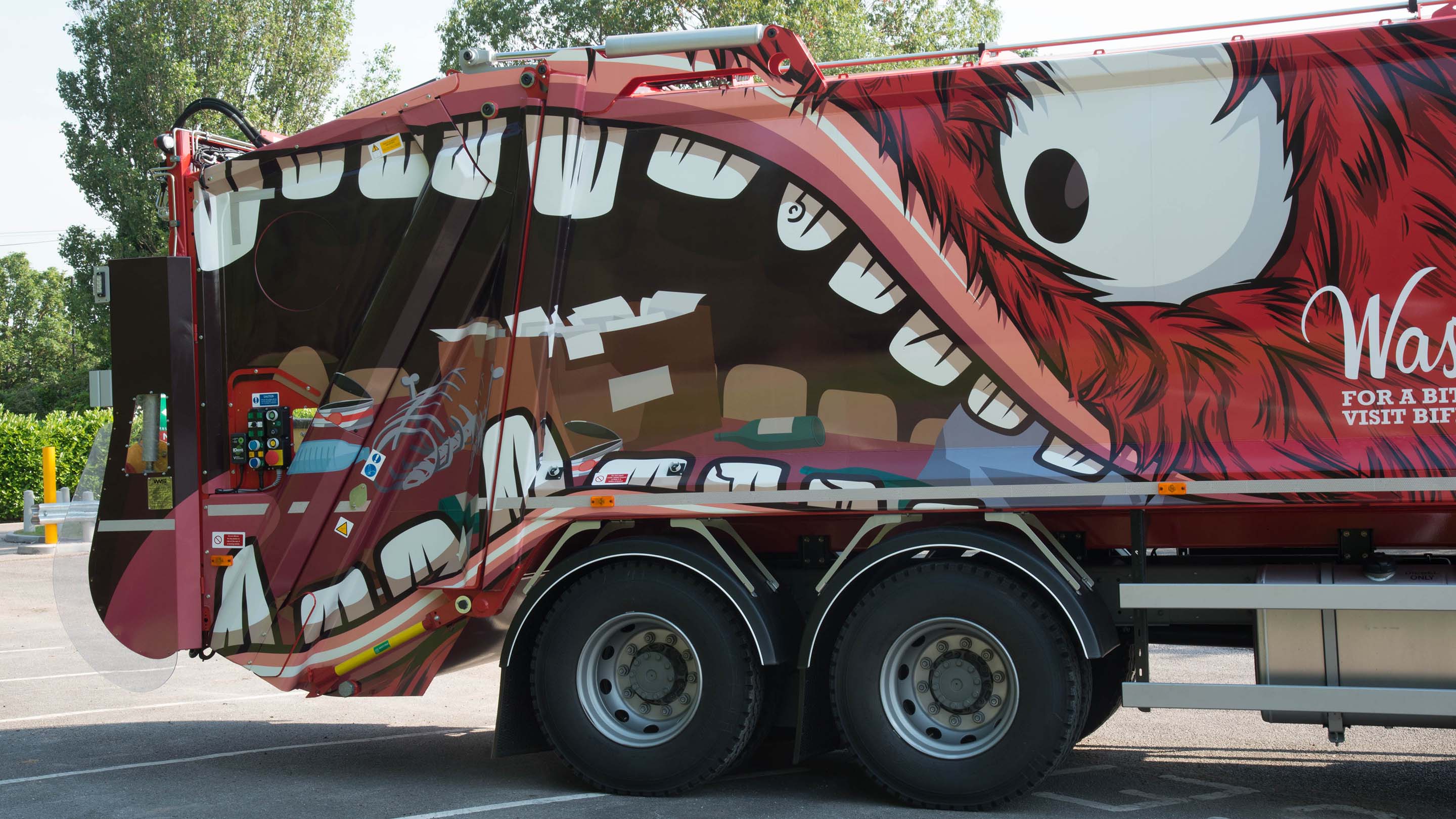 Side image of a Biffa garbage truck with a illustrator of a monster on the side