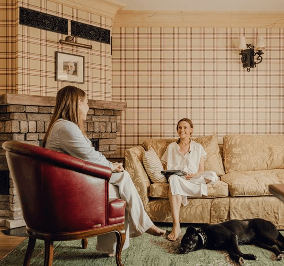 Two womans talking to each other in the room