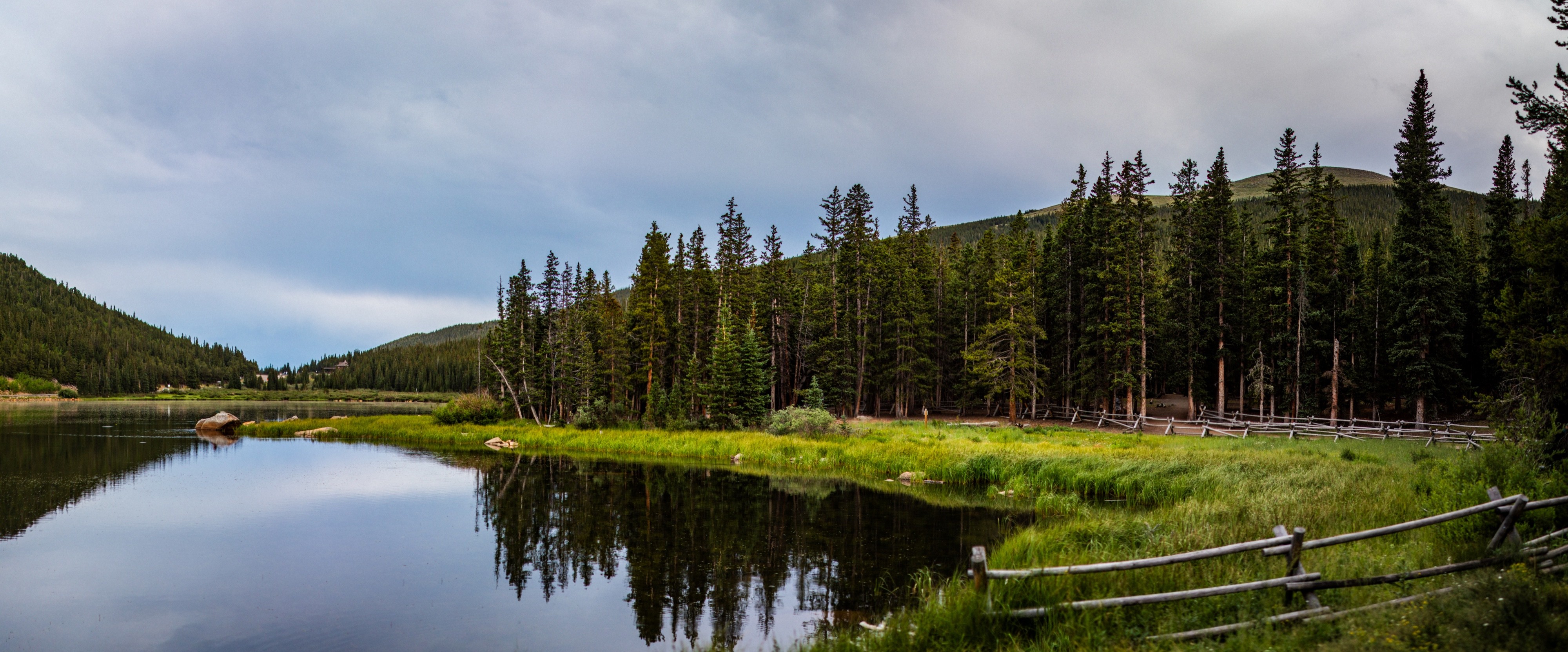 Panoramic landscape photograph of mountains, water, desert, or coast by Lucas Jensen